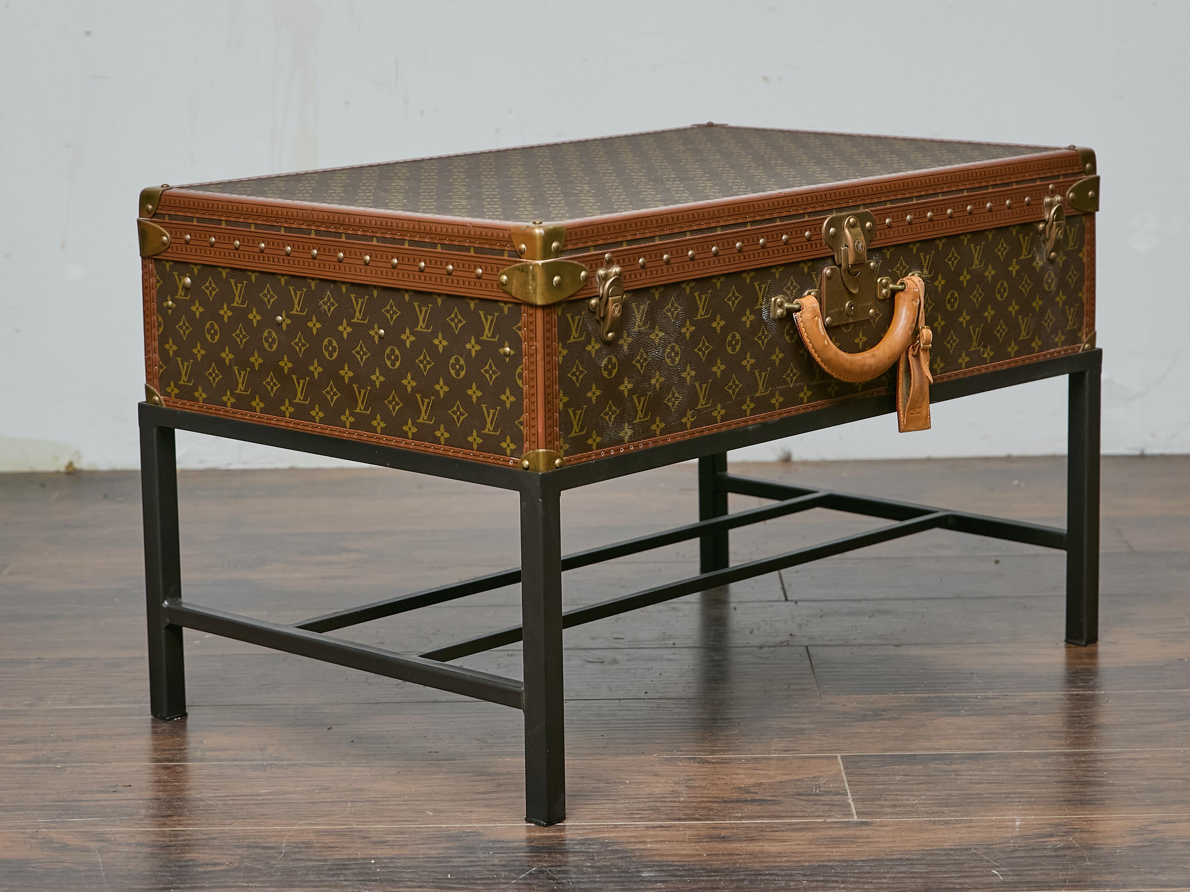 A vintage Louis Vuitton trunk from the late 1970s to early 1980s finds new life as a distinctive coffee table, seamlessly blending luxury with functionality. The monogrammed canvas, framed by signature lozine trim and reinforced brass hardware,