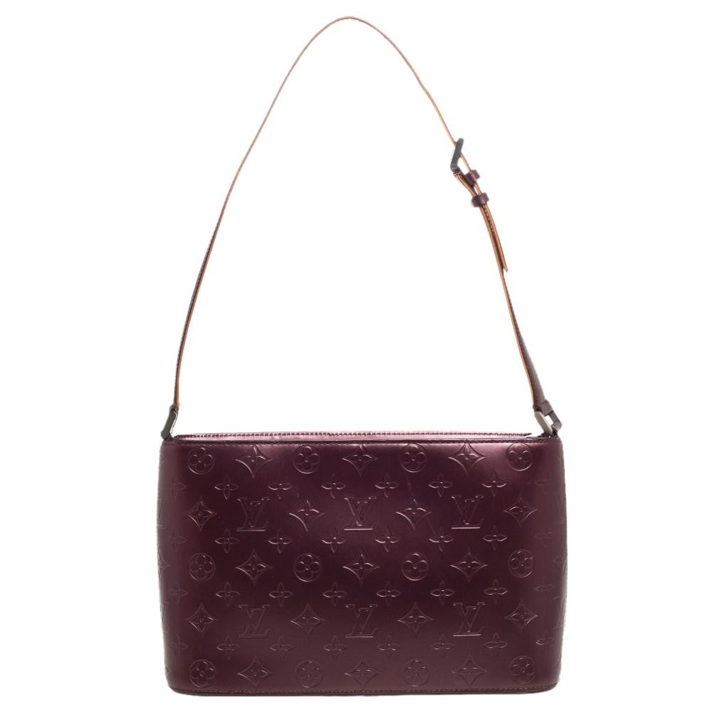 Louis Vuitton's Allston bag has a compact silhouette and a whole lot of style. It is crafted from the signature monogram mat leather and detailed with a front flap pocket. It carries an adjustable shoulder strap and comes equipped with a