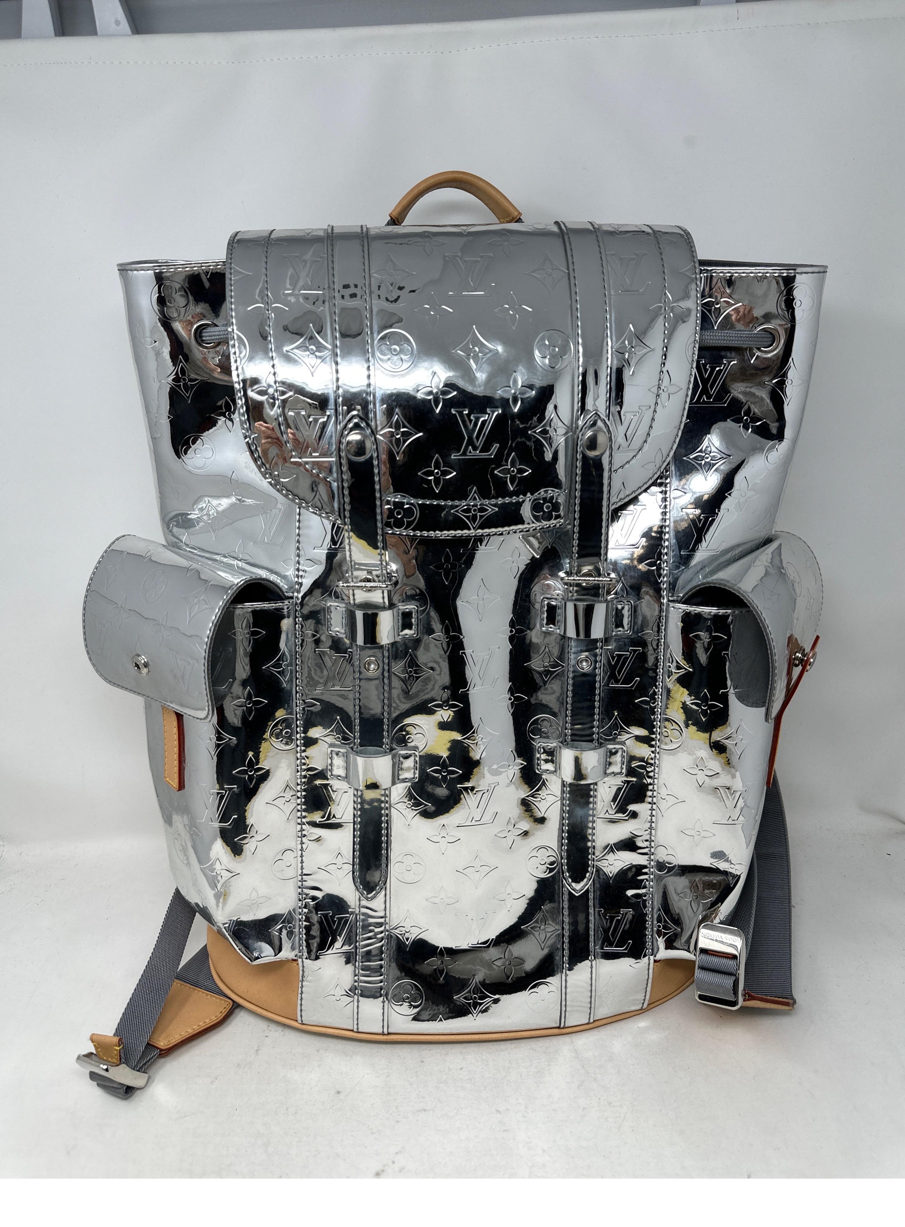 Louis Vuitton Virgil Abloh Christopher Mirror Backpack. Rare collector's piece designed by Virgil Abloh for the LV Mirror Mirror Capsule Fall-Winter 2021-2022 Fashion Show. Monogram mirror coated canvas with leather trim introduced by Virgil. Called