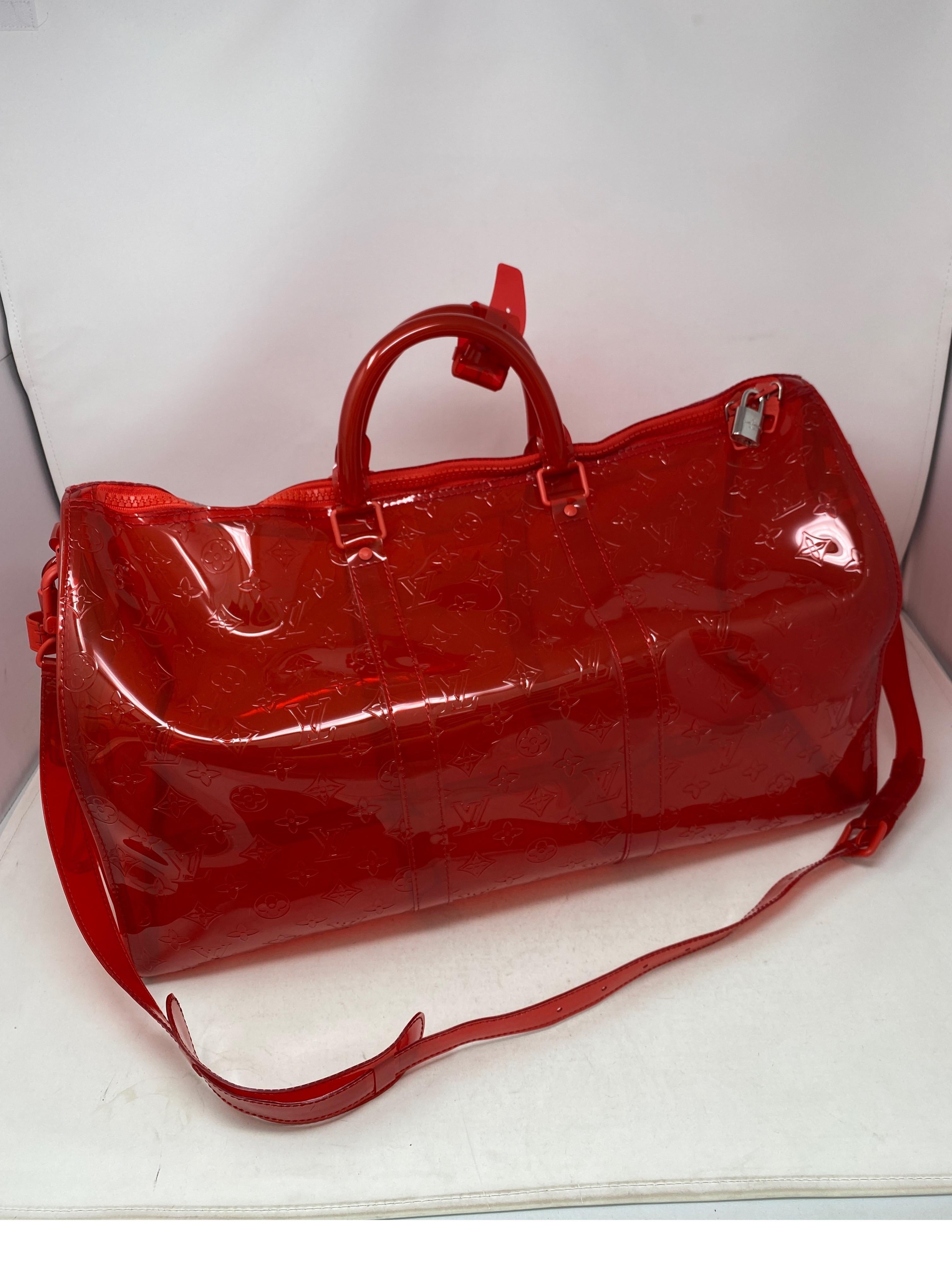 Louis Vuitton Virgil Abloh Red Vinyl Keepall Bandouliere Bag. Rare and limited edition. Clear red plastic travel bag by Virgil. Iconic design meets best of street casual. Collector's piece. Don't miss out. Guaranteed authentic. 