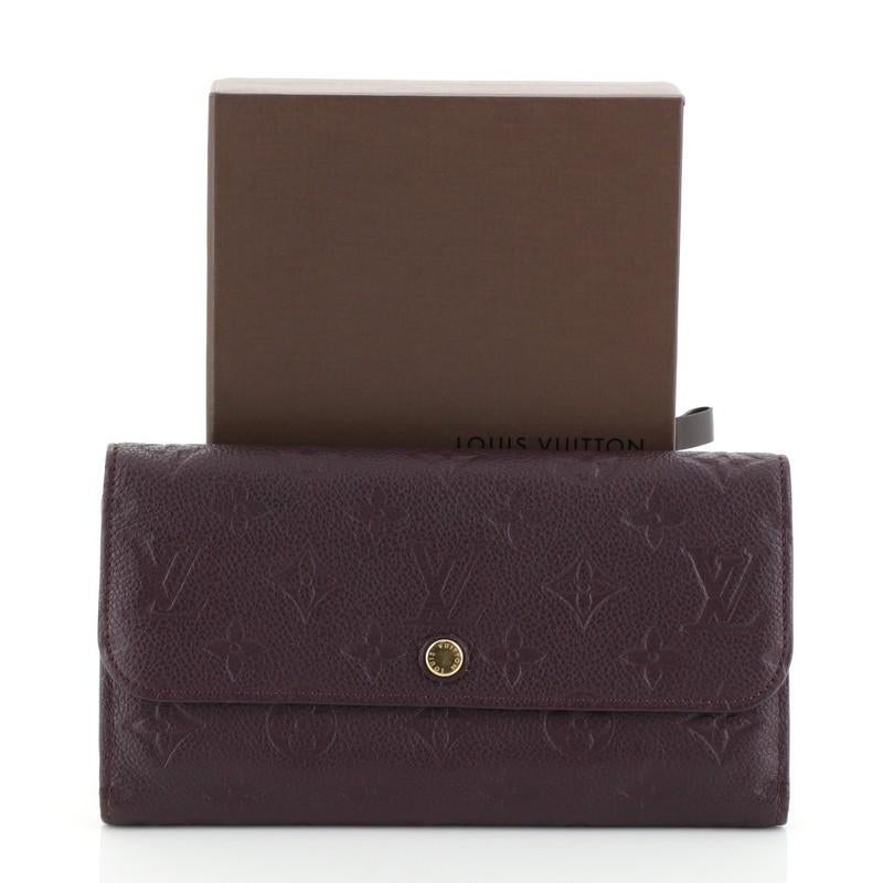 This Louis Vuitton Virtuose Wallet Monogram Empreinte Leather, crafted from purple monogram empreinte leather, features gold-tone hardware. Its snap button closure opens to a purple leather interior with multiple card slots, slip pocket and zip