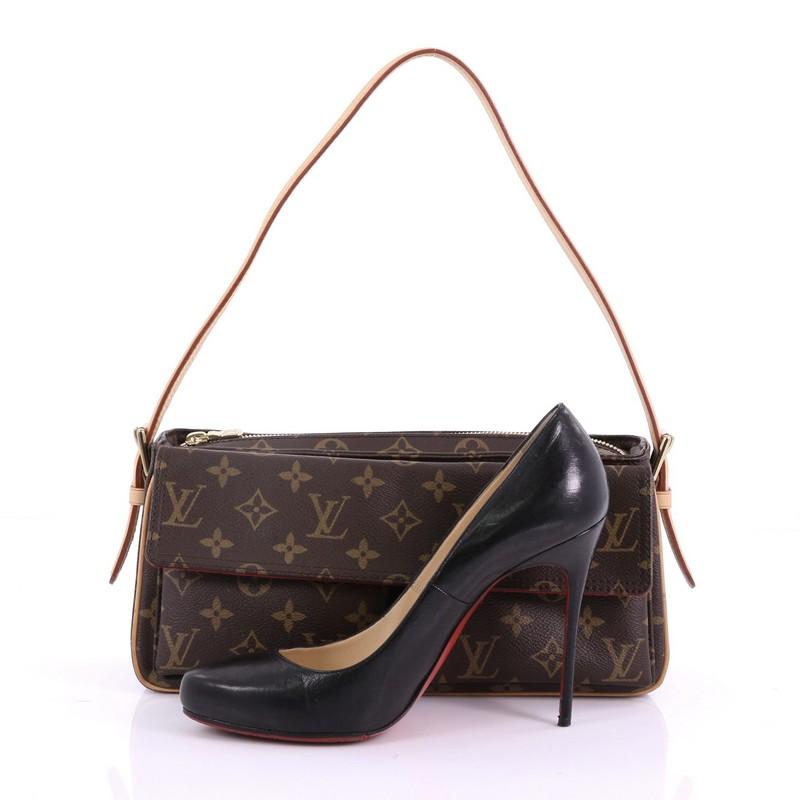 This Louis Vuitton Viva Cite Handbag Monogram Canvas MM, crafted in brown monogram coated canvas, features a single vachetta leather strap, two exterior flap pockets with dual magnetic snap closures, and gold-tone hardware. Its top zip closure opens