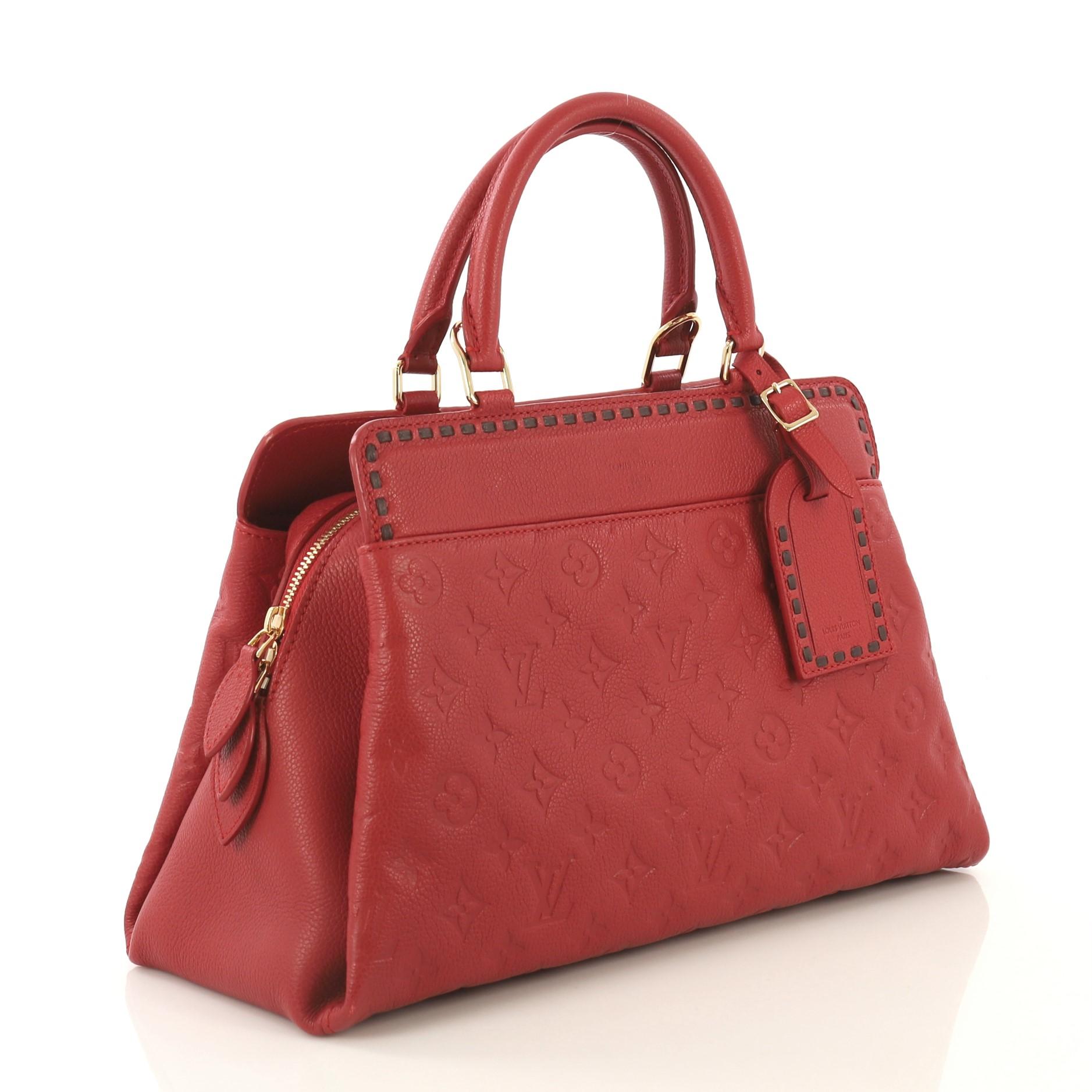 This Louis Vuitton Vosges Handbag Whipstitch Monogram Empreinte Leather MM, crafted from red monogram empreinte leather, features dual rolled leather handles, stitched detailing, and gold-tone hardware. It opens to a red fabric interior divided into