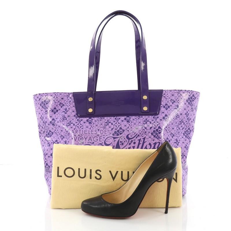 This Louis Vuitton Voyage Tote Cosmic Blossom PM, crafted from purple patent leather with cosmic monogram flower prints, features dual flat patent leather handles, protective base studs and gold-tone hardware. Its hook clasp closure opens to a