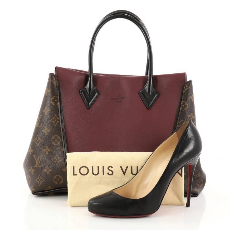 This authentic Louis Vuitton W Tote Monogram Canvas and Leather PM presented in the brand's 2013 Collection is a collector's dream. Crafted in maroon leather and brown monogram coated canvas sides, this luxurious and elegant tote features