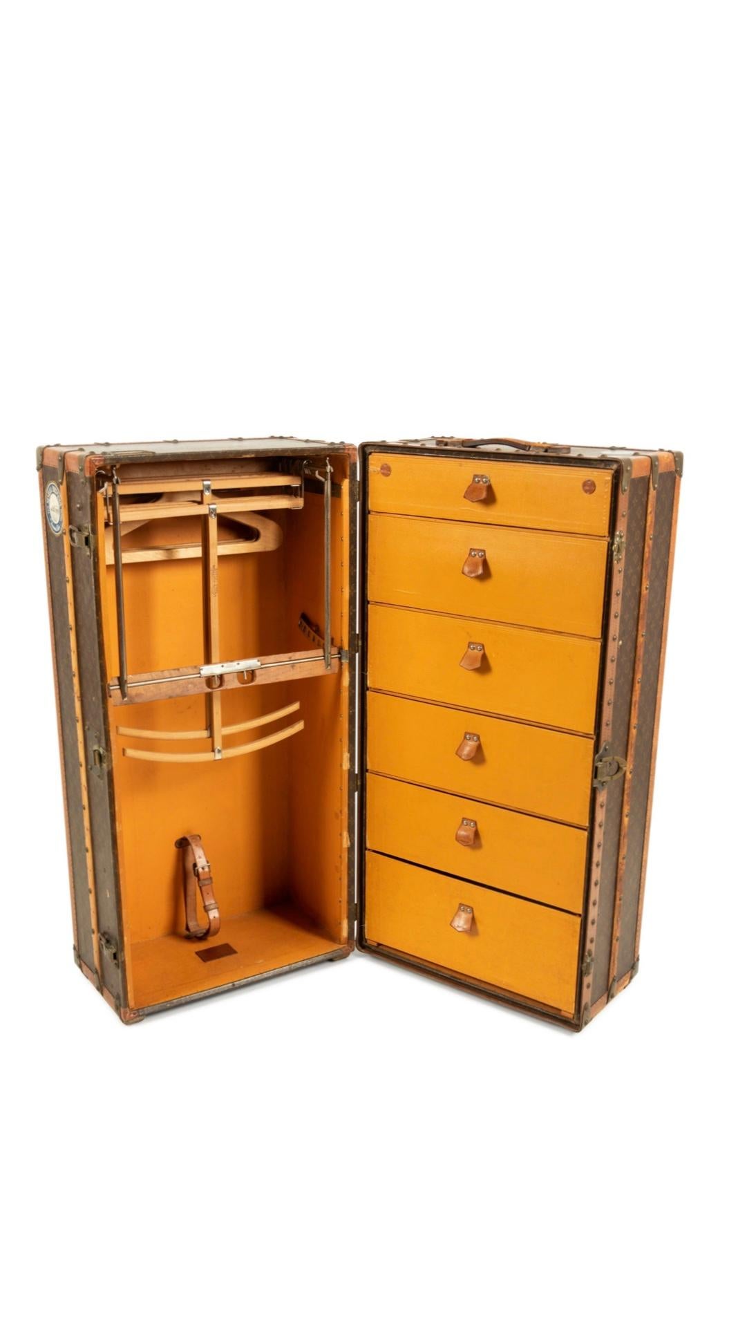 Louis Vuitton Wardrobe Steamer trunk, early 20th century

Wardrobe trunk covered in monogram canvas with natural Lozine leather trim and handles, and brass hardware with front lock and key. The interior has wood LV hangers and dust ruffle on