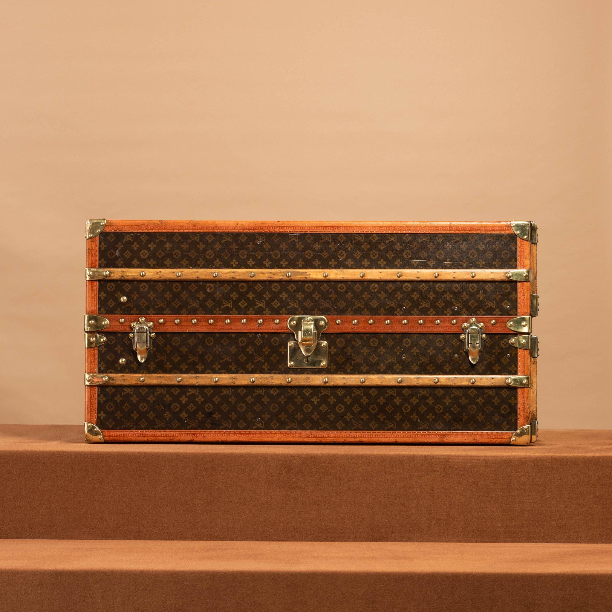 A Louis Vuitton wardrobe trunk with 50/50 internal layout of hanging space on both sides and felt lined lift out shoeboxes; circa 1940. Has polished brass exterior fittings and lozine trim. One of the leather handles of this trunk has been replaced