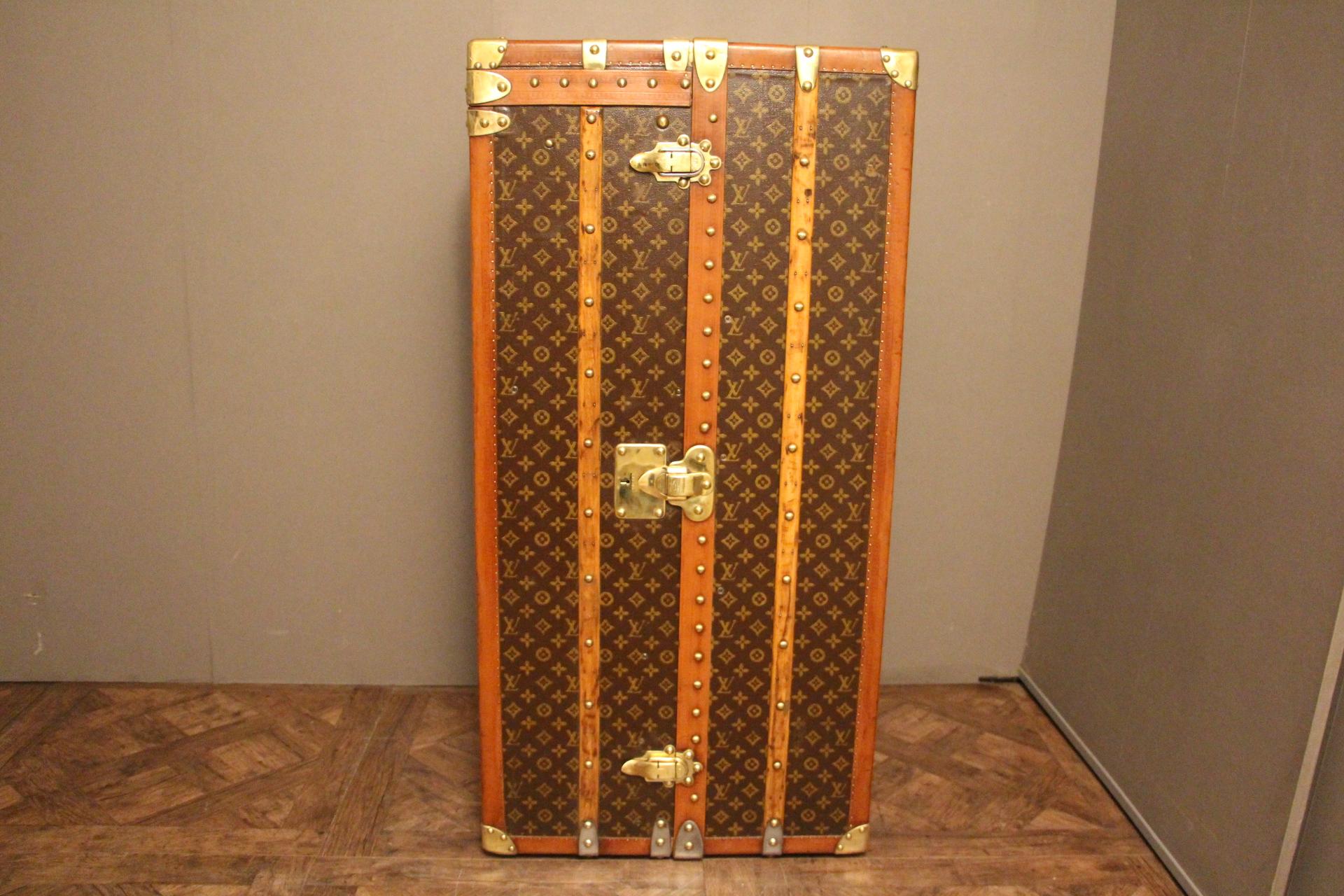 This impressive 1930s Louis Vuitton wardrobe features stenciled monogram canvas, lozine trims, brass LV stamped locks and studs as well as its lift top. It has got a beautiful warm patina.
Customized painted yellow red stripes on the top add