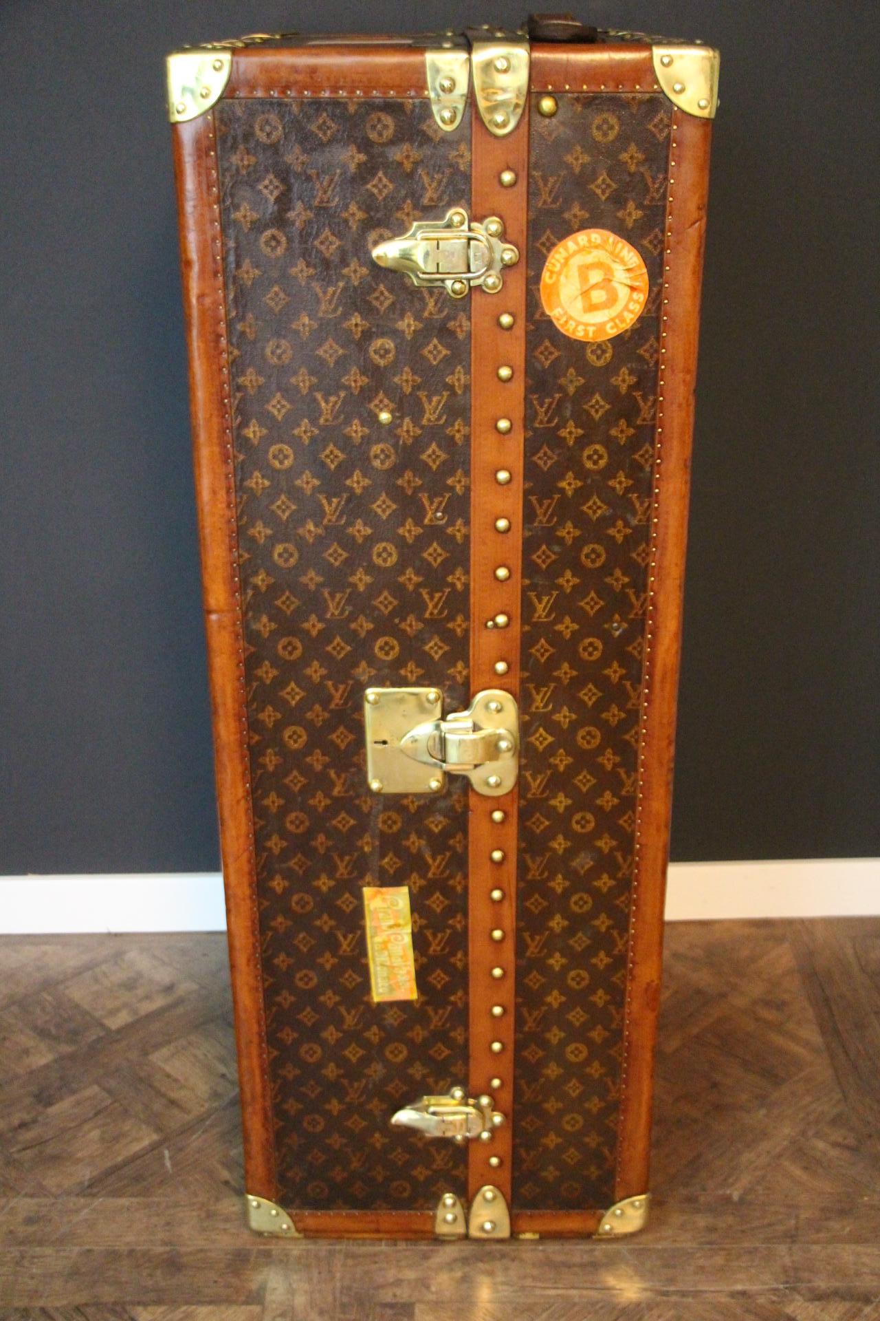 This superb Louis Vuitton wardrobe features stenciled monogram canvas, lozine trims and solid brass lock, clasps and studs.
Lock, clasps and studs are all marked Louis Vuitton. Customised hand painted French flag on its top and on its bottom adds