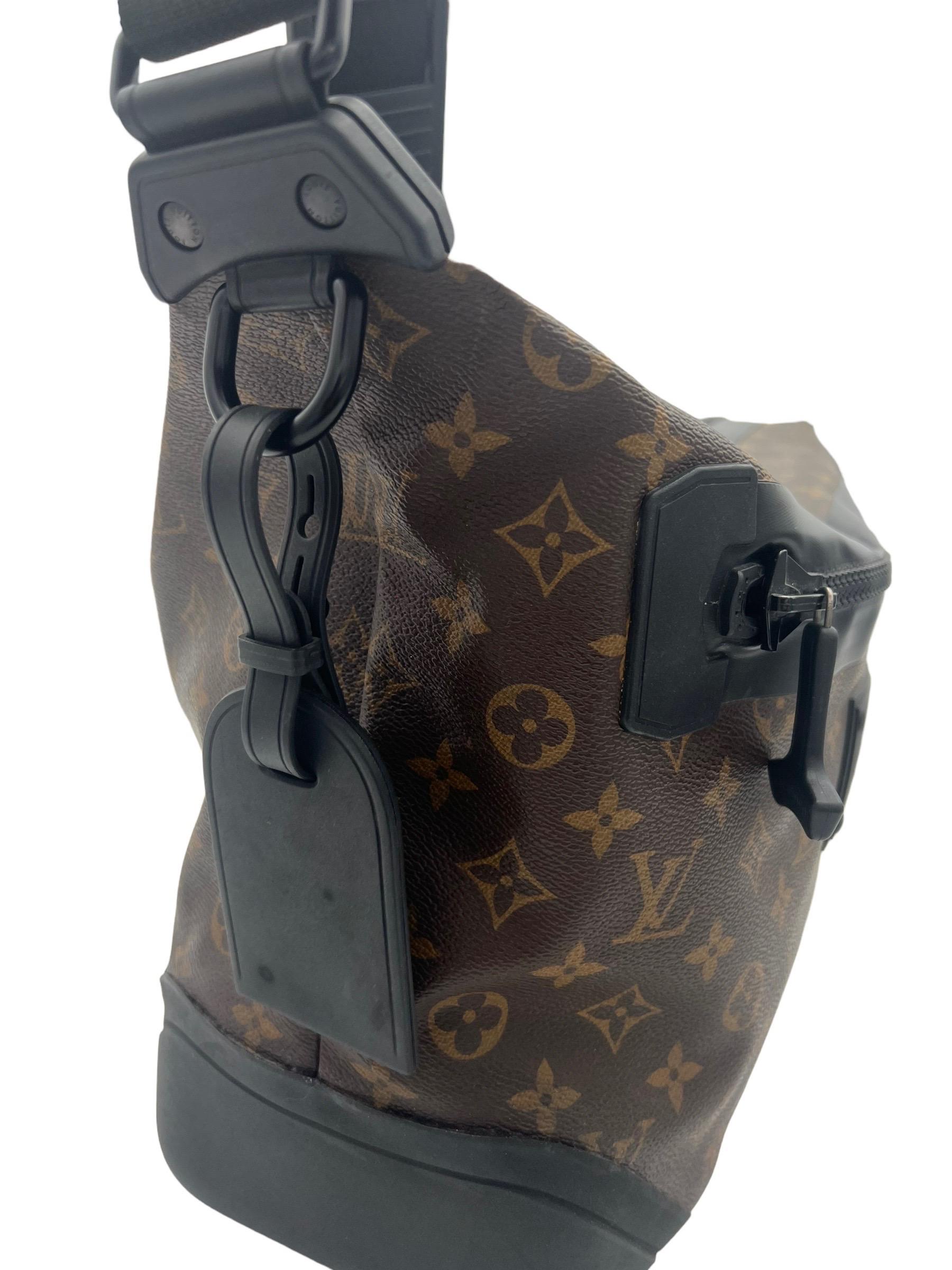 Louis Vuitton bag, Voyage Waterproof model, made in monogram canvas with black macasser inserts and hardware. Equipped with zip closure and front zip pocket. Both closures are reinforced with waterproof fabric as well as the lower corners.