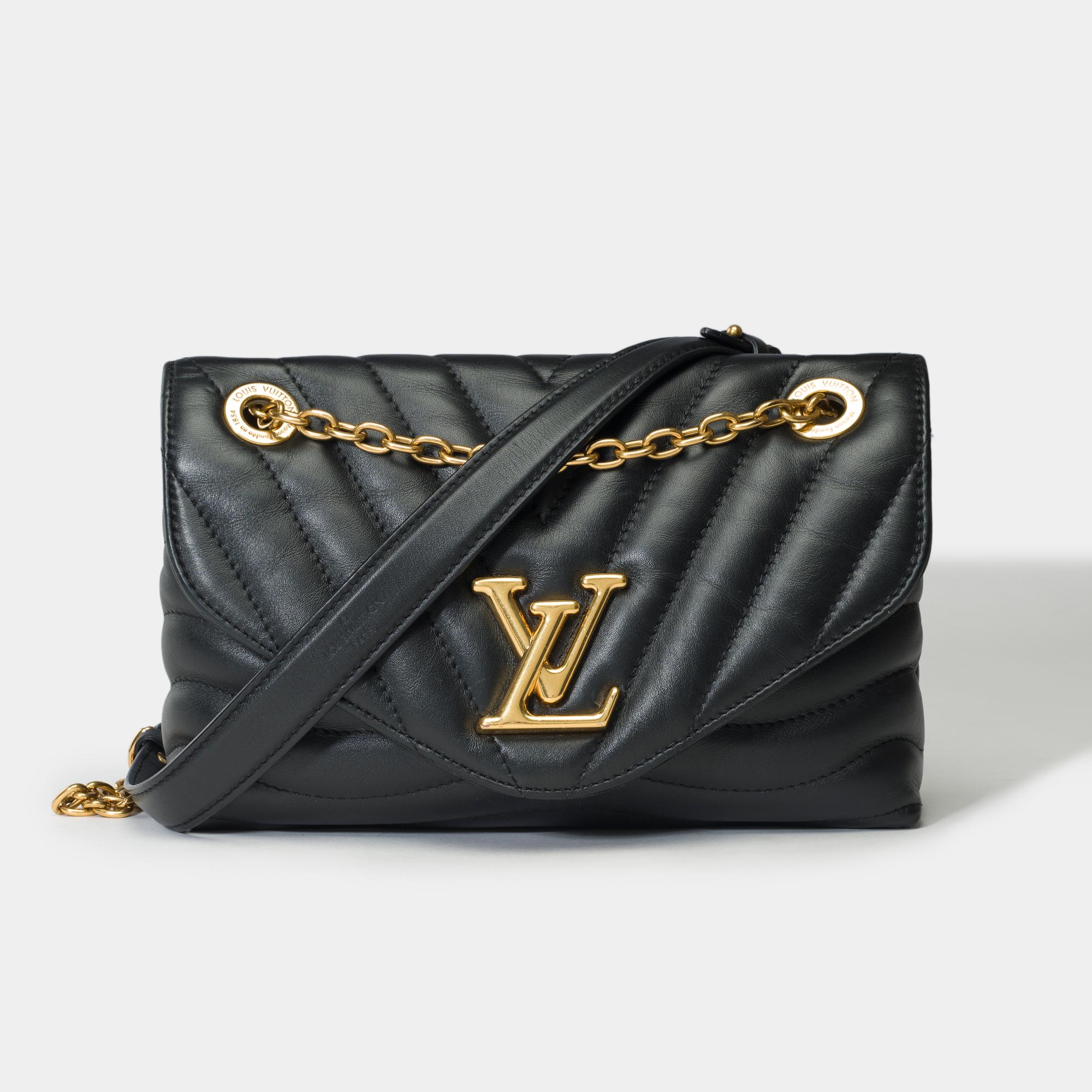 Crafted​ ​from​ ​soft,​ ​padded​ ​calf​ ​leather,​ ​this​ ​New​ ​Wave​ ​chain​ ​bag​ ​comes​ ​in​ ​black.​ ​The​ ​aged​ ​gold​ ​finish​ ​of​ ​the​ ​iconic​ ​LV​ ​lock​ ​and​ ​metal​ ​parts​ ​lend​ ​this​ ​model​ ​a​ ​retro​ ​look.​ ​Thanks​ ​to​