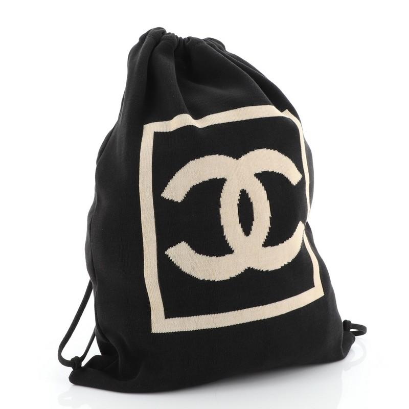 This Chanel Sport Line Drawstring Backpack Jersey, crafted from black jersey, features CC logo on front and drawstrings that double function as shoulder straps. Its drawstring closure opens to a neutral jersey interior. Hologram sticker reads: