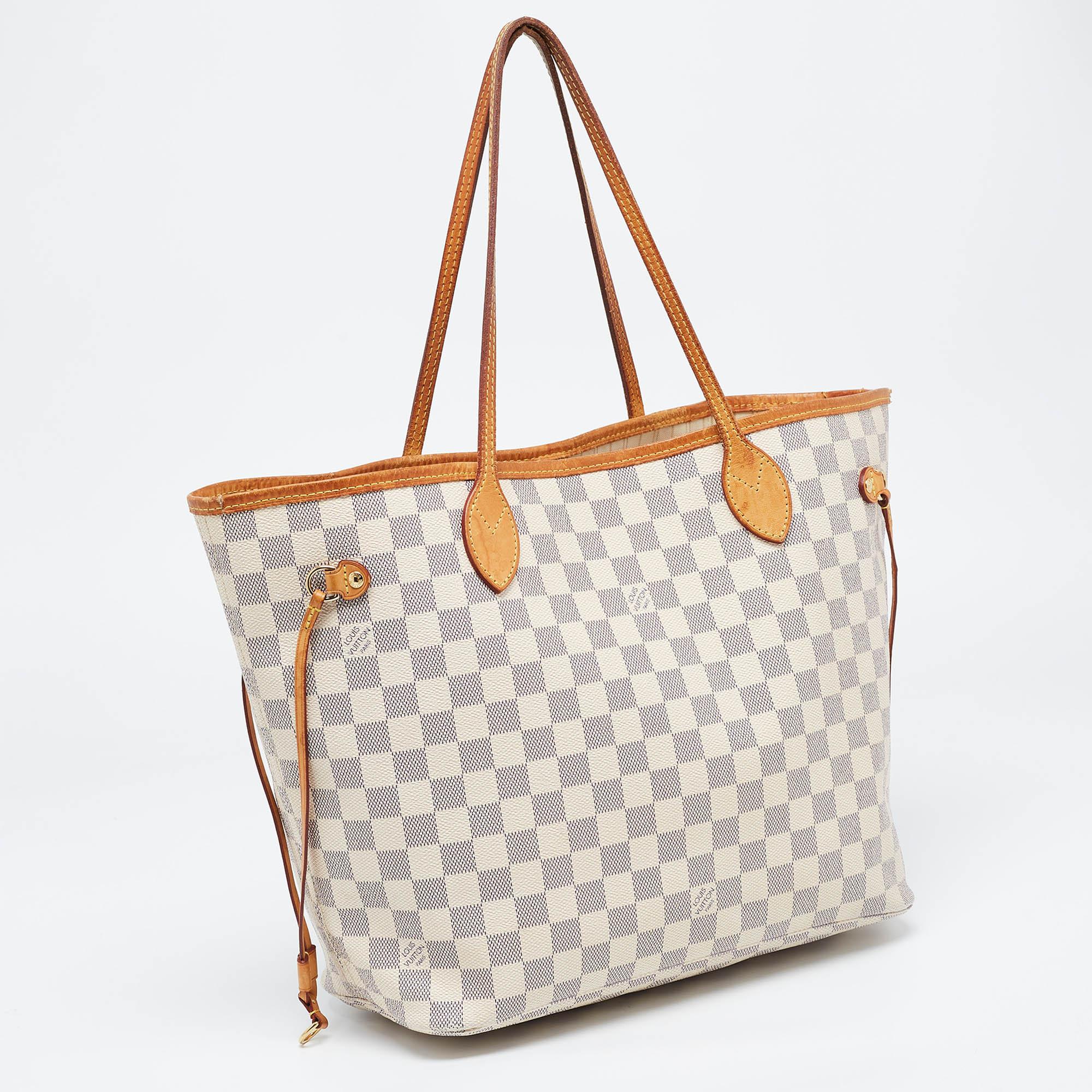 Introduced in 2007, the Neverfull by Louis Vuitton is applauded for its innovative design and faultless craftsmanship. This MM bag comes crafted from Damier Azur canvas, and its classy features contribute to its timeless elegance. It is held at the