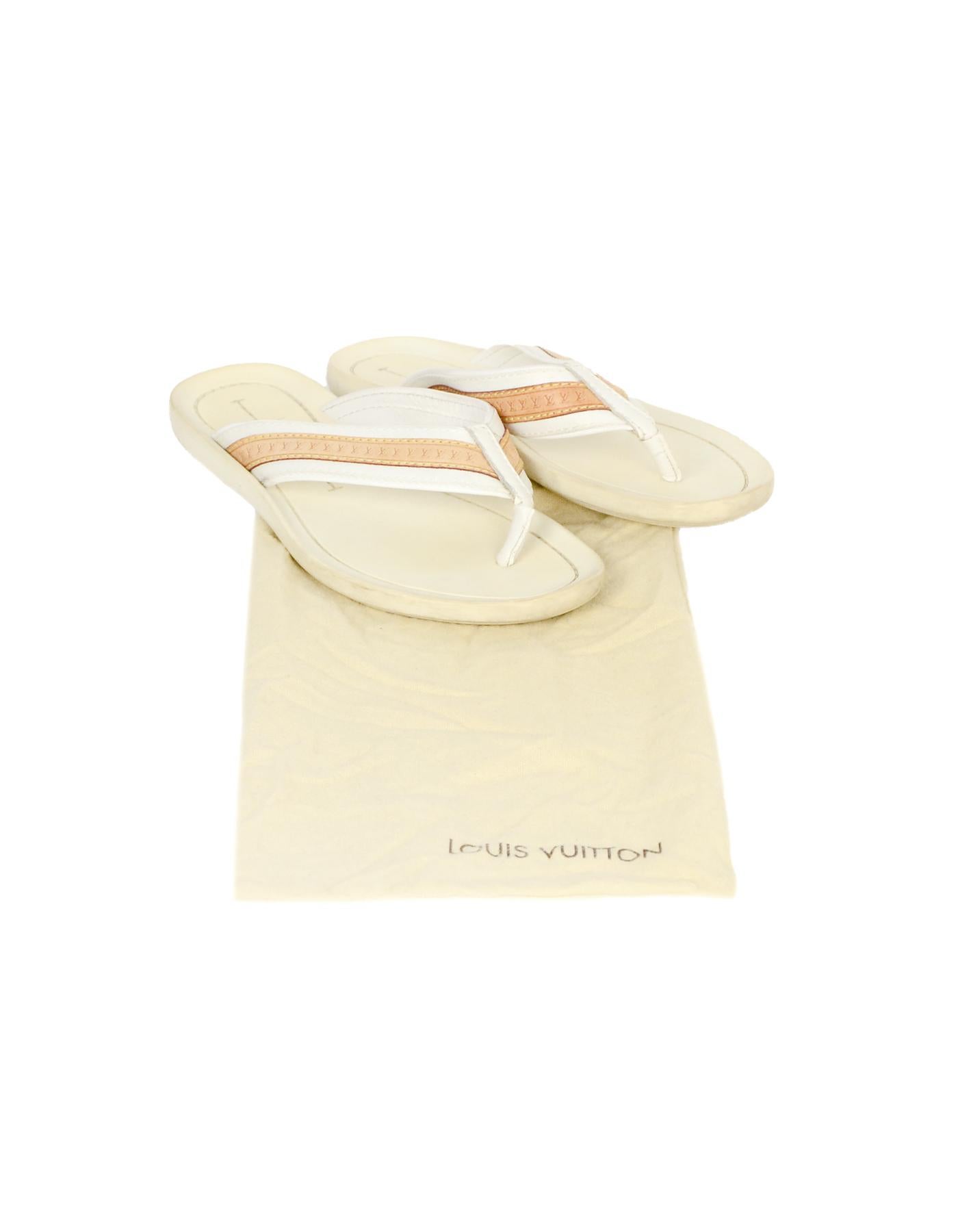 Louis Vuitton White Canvas/Leather Logo Thong Sandals Sz 38

Made In: Italy
Year of Production: 2006
Color: White, tan
Materials: Canvas, leather, rubber
Closure/Opening: Slide on
Overall Condition: Good pre-owned condition with exception of some