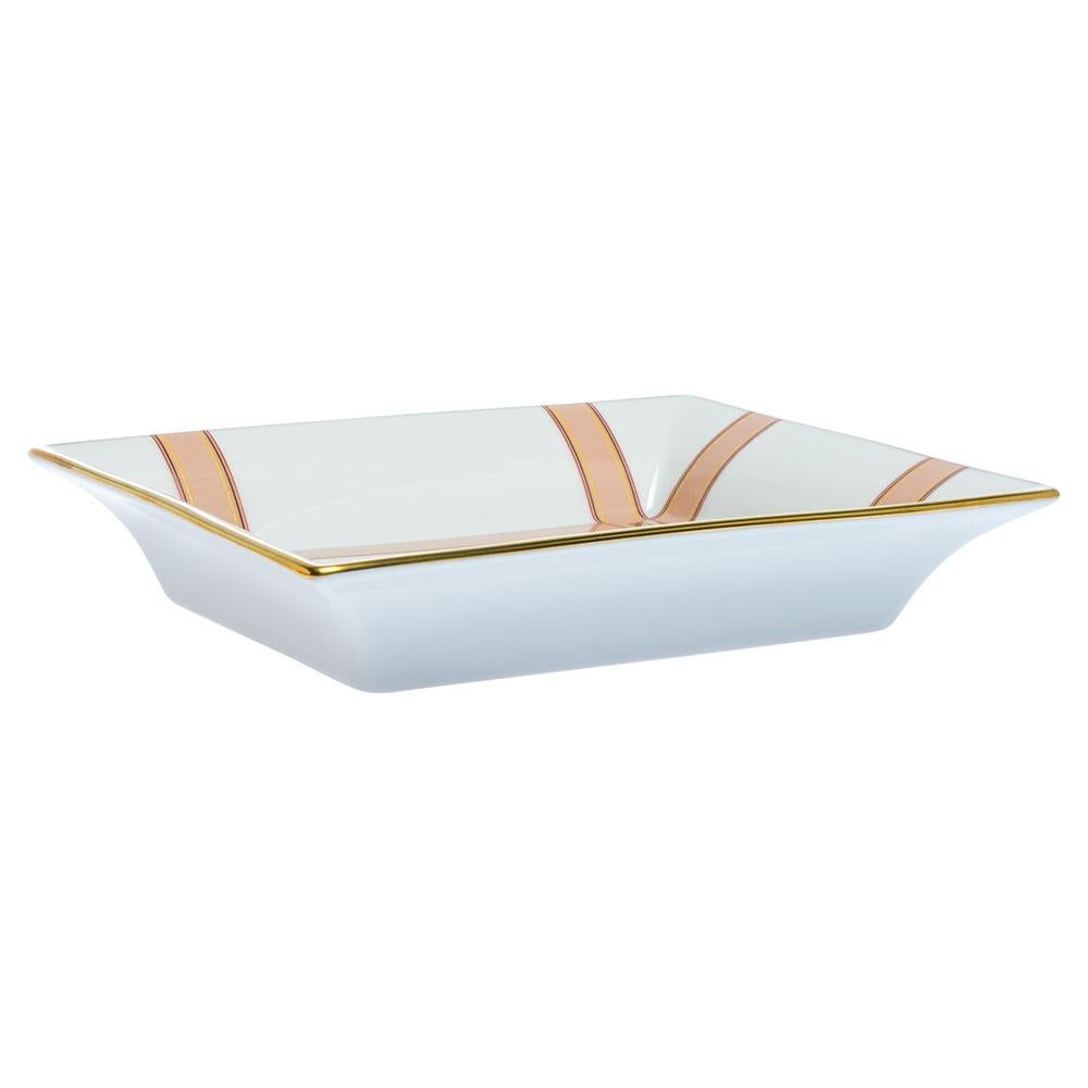 Louis Vuitton's Marcel MM valet tray is beautifully made from white ceramic and shaped to keep your things organised. The design on it mimics leather straps punctuated with gold-tone studs and the timeless LV logo.

Includes:Original Box
