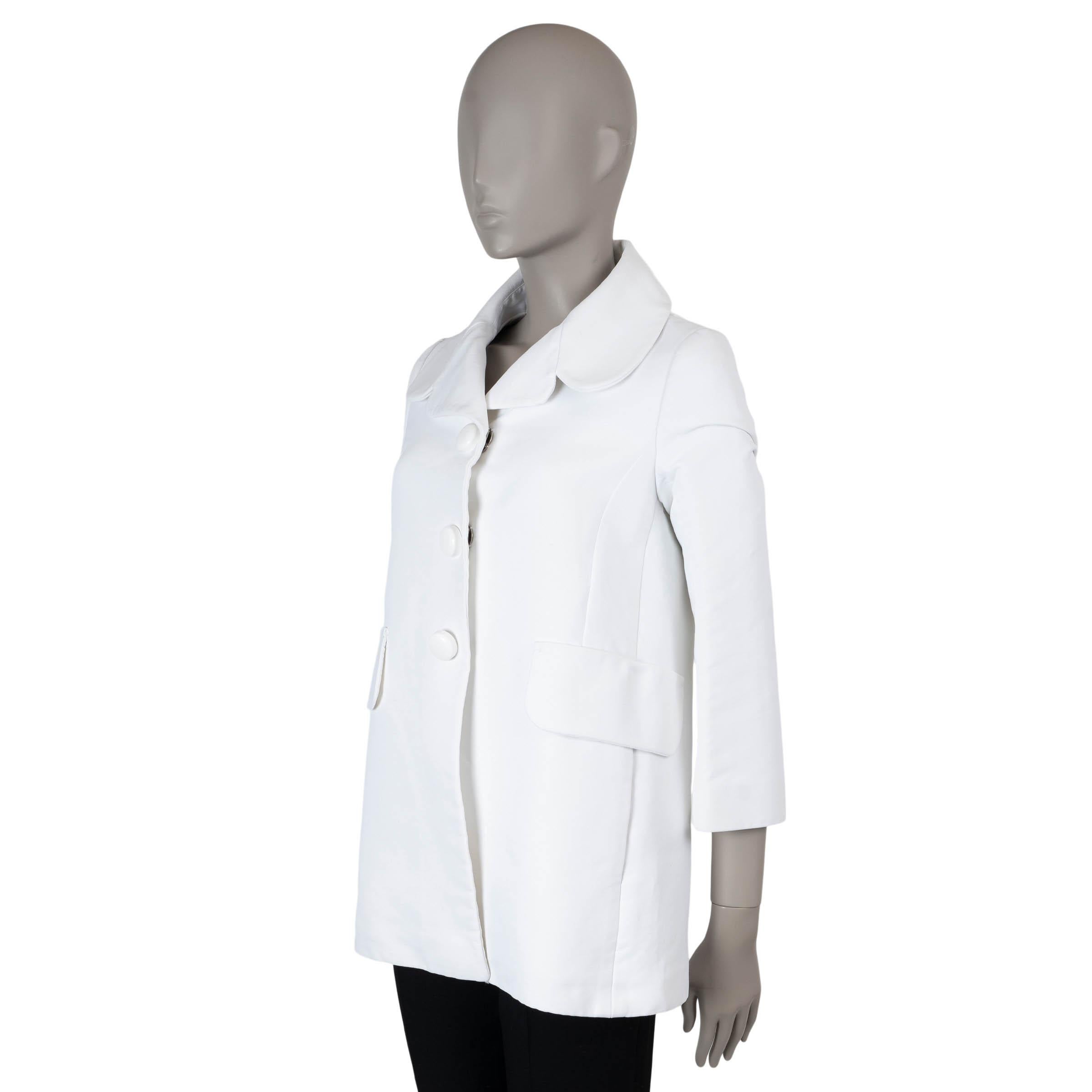 Questo cappotto corto di Louis Vuitton, autentico al 100%, è realizzato in twill di cotone (75%) e poliammide (25%) e presenta una silhouette ad A di ispirazione modaiola con revers a lancia e tasche con patta/spacco. Si chiude con grandi bottoni