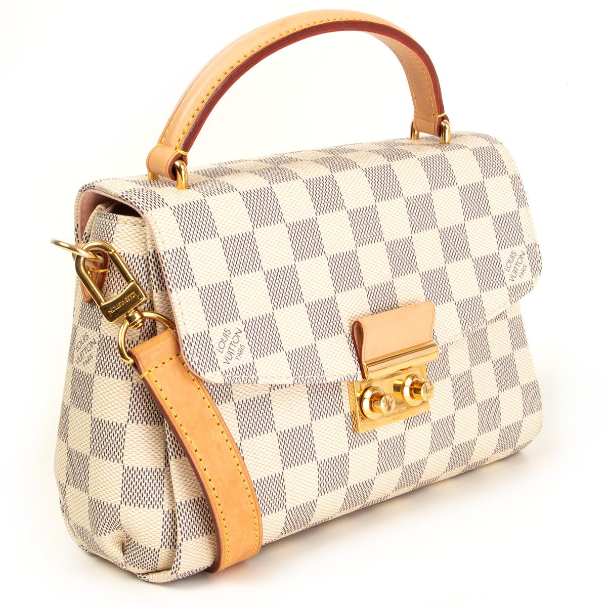 100% authentic Louis Vuitton Croisette crossbody bag in white Damier Azur canvas with natural leather top handle and adjustable and detachable shoulder strap. Closes with a lock on the front. Lined in pink alcantara with an open pocket against the