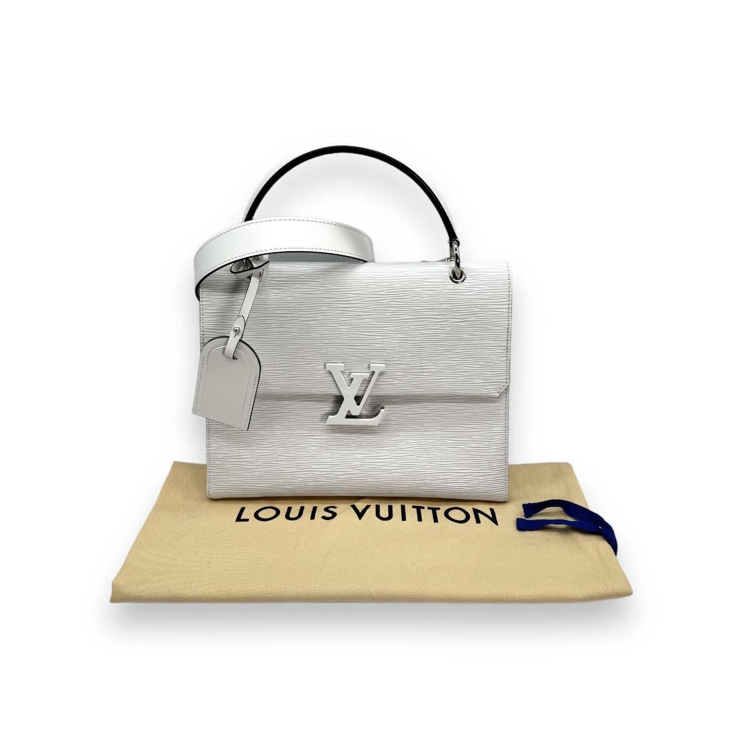 Indulge in luxury with the Louis Vuitton White Epi Grenelle MM Handbag. Crafted with Epi Grained White Leather and finished with silver-tone hardware, this handbag exudes elegance and sophistication. Featuring a spacious interior with multiple