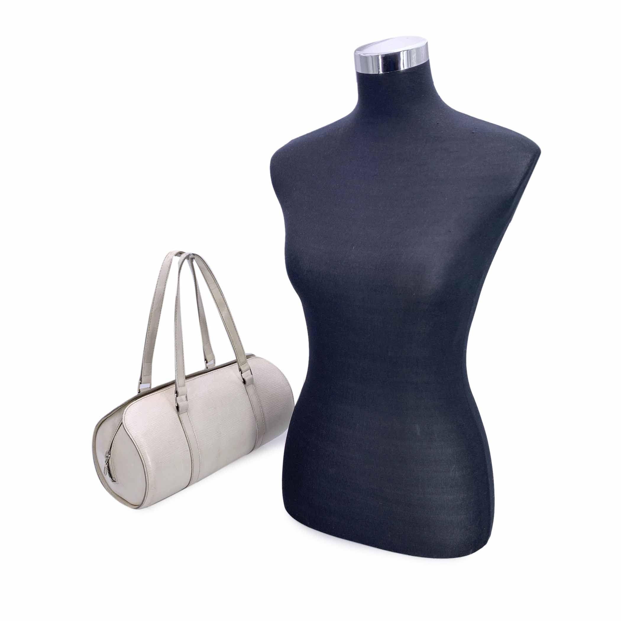 This beautiful item will come with a Certificate of Authenticity provided by Entrupy. The certificate will be provided at no further cost Step into the world of refined elegance with the Louis Vuitton 'Soufflot' bag, crafted in luxurious white Epi