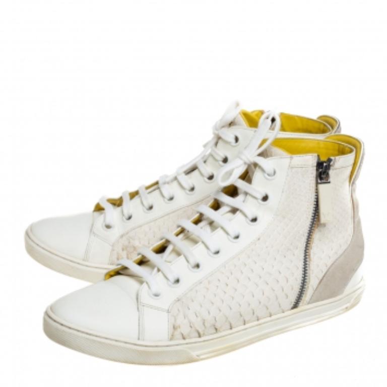 These Louis Vuitton high-top sneakers are stunning. Crafted in Italy, they are made of white python skin and leather as well as grey suede. They come with lace fronts, brand detail on the tongue, zip fastenings, leather lining and insoles, and
