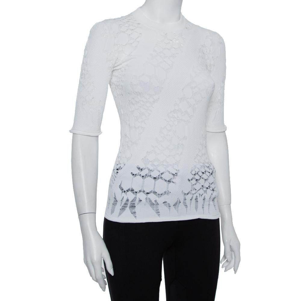 Go for stylish comfort with this top from Louis Vuitton that brings a design apt for all seasons. This elegant white lace top can be easily teamed with skirts, pants, or shorts. Made from a blend of fabrics, it has a crew neckline and short