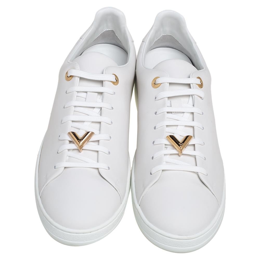 The House of Louis Vuitton flaunts its expertise in creating upscale footwear by making these Frontrow sneakers. They are crafted from white leather with lace-up detail and a gold-toned V motif decorating the vamps. They are fitted with gold-toned