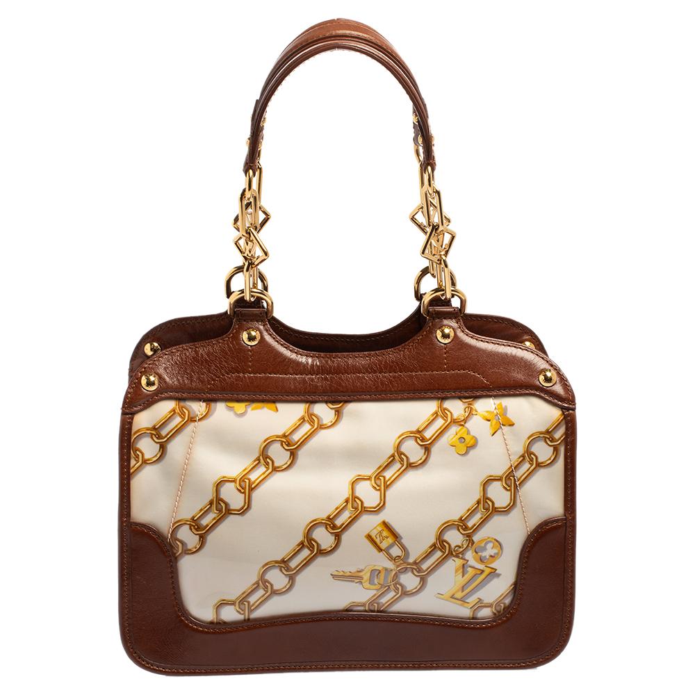 This limited edition creation is for all Louis Vuitton collectors and lovers alike. Meticulously crafted from vinyl, satin, and leather trims, this dream bag is held by two handles and decorated with charms print all over. It comes in a structured