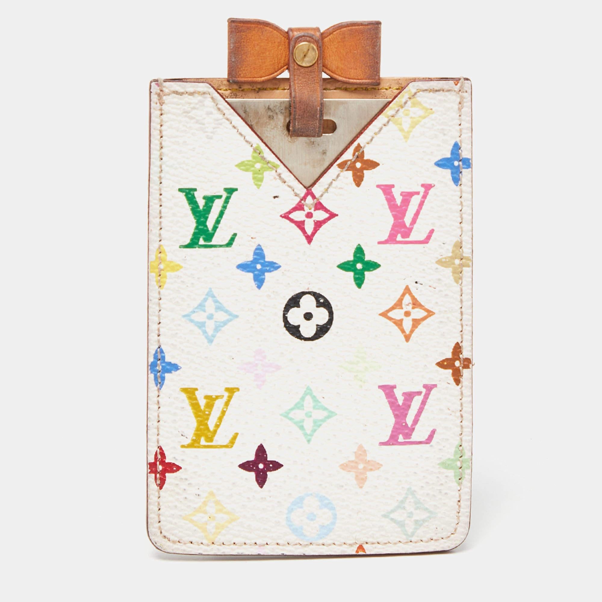A small mirror with a leather bow on top comes nestled in a signature LV case. The case is made of Multicolore Monogram canvas and it has tonal stitching.