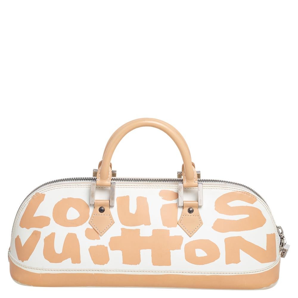 This version of the iconic Louis Vuitton Alma has an elongated horizontal silhouette made using white leather and decorated with graffiti work in a peach hue. Silver-tone hardware gives the bag a fine finish.

Includes: Original Dustbag, Info Booklet