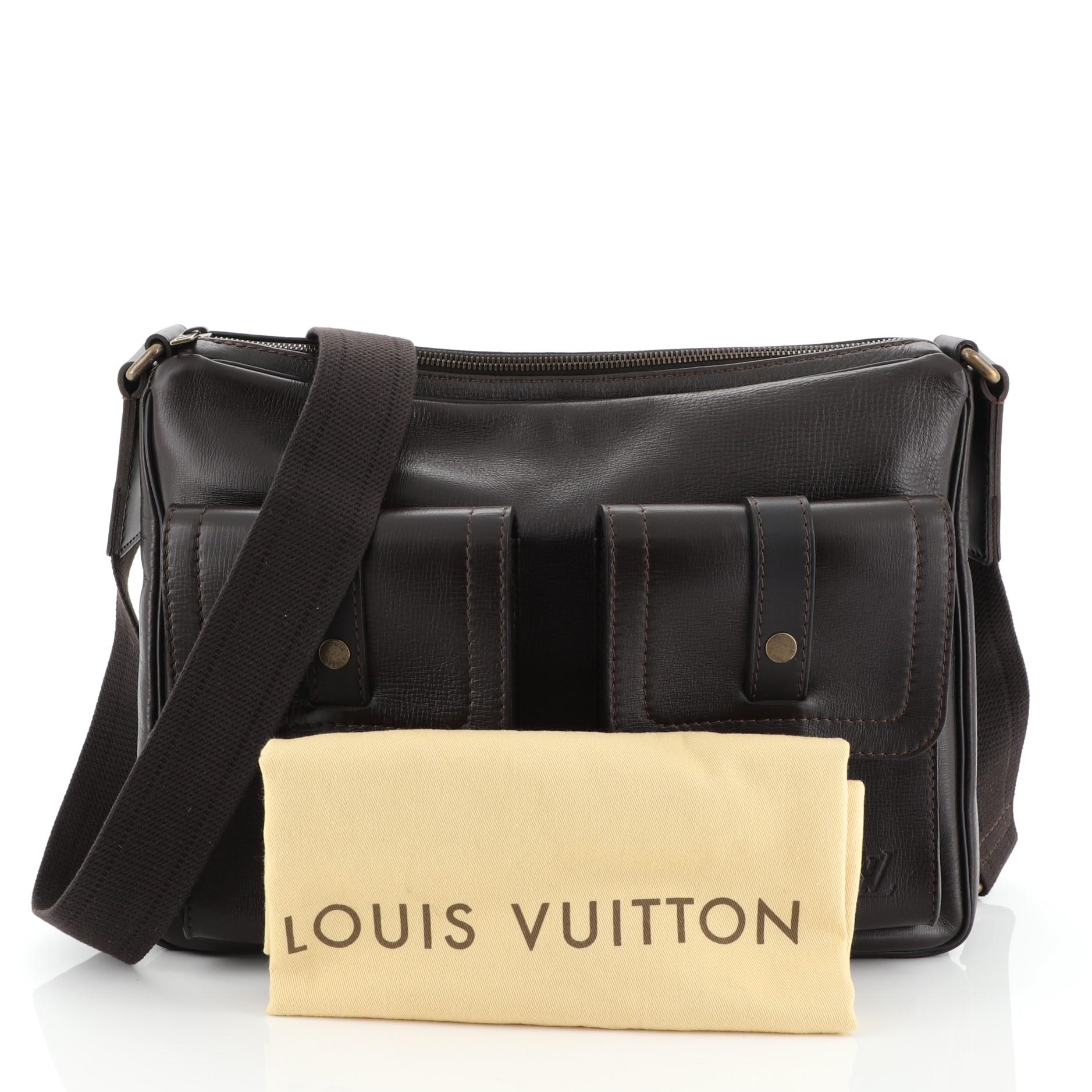This Louis Vuitton Wichita Utah Leather, crafted in brown leather, features an adjustable canvas strap, two exterior flap pockets and aged gold-tone hardware. Its zip closure opens to a brown fabric interior with slip pockets. Authenticity code