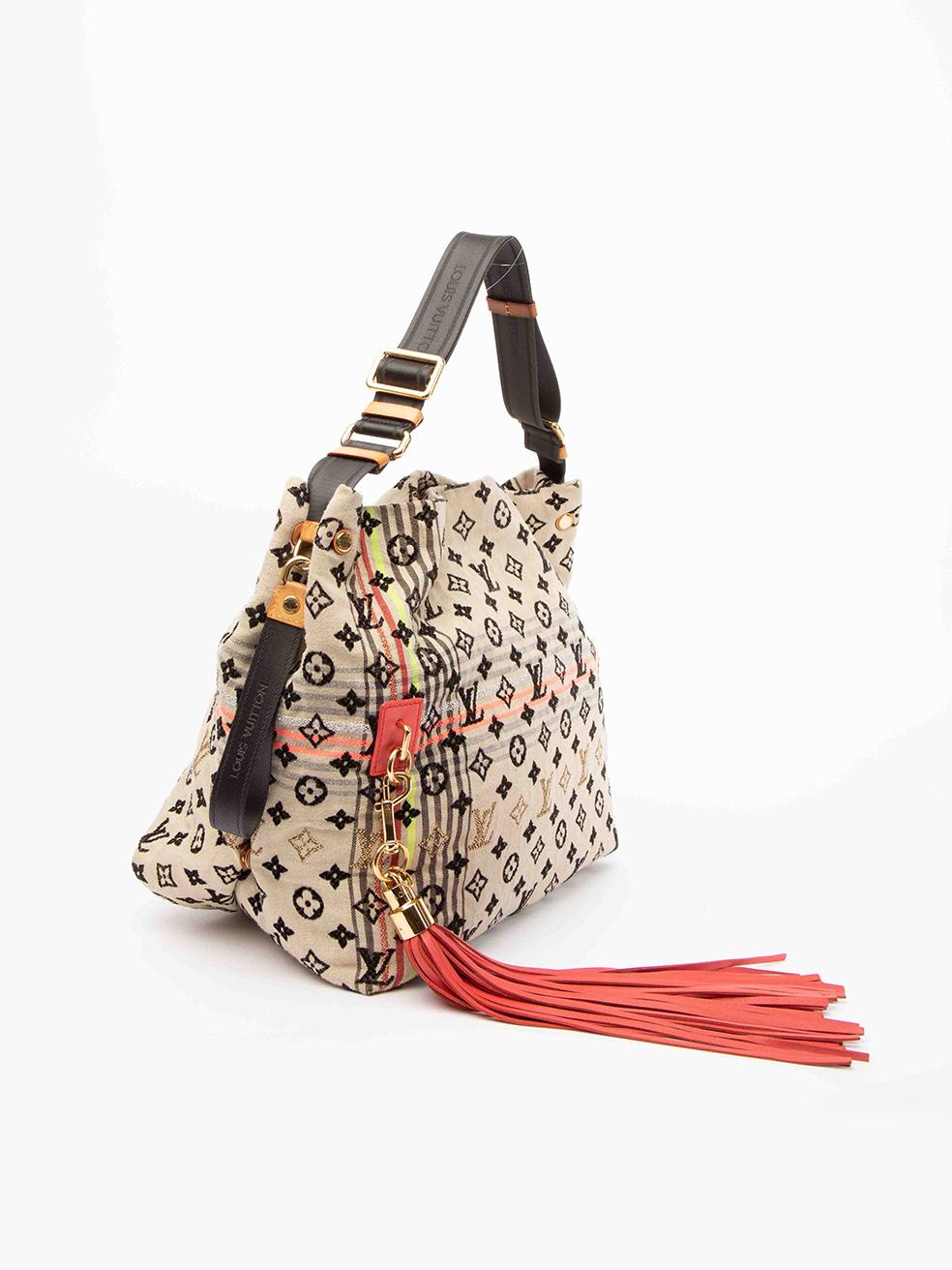 CONDITION is Good. Minor wear to bag is evident. Minimal wear to the outer fabric which is a bit dull and pilling can be seen. There is small stain at the bottom of the bag and also wear to the interior. The leather details around the bag ae also