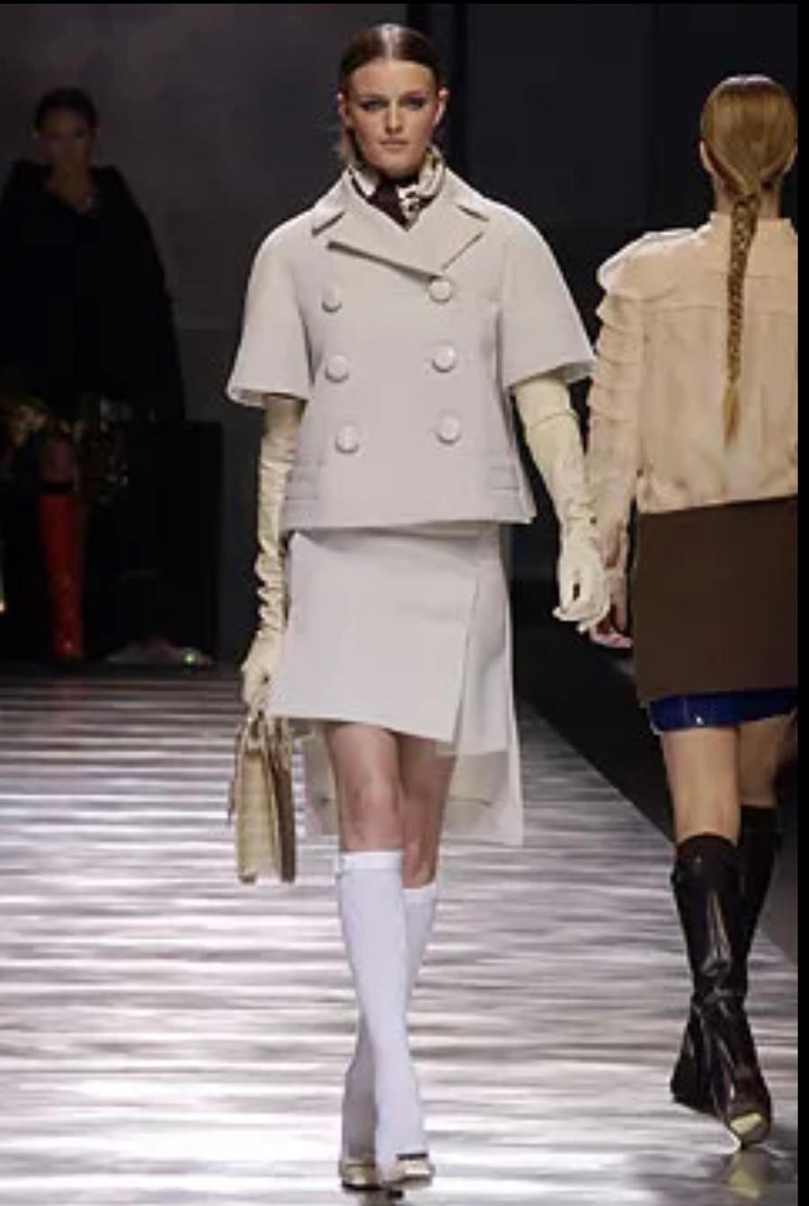 Super rare, futuristic fabulous vintage Louis Vuitton grey panelled skirt from Marc Jacobs’ Fall 2003 collection. Look 20 on the runway. Unworn with tag and spare grosgrain trim. Made from soft, mid weight pearl grey wool flannel with grosgrain