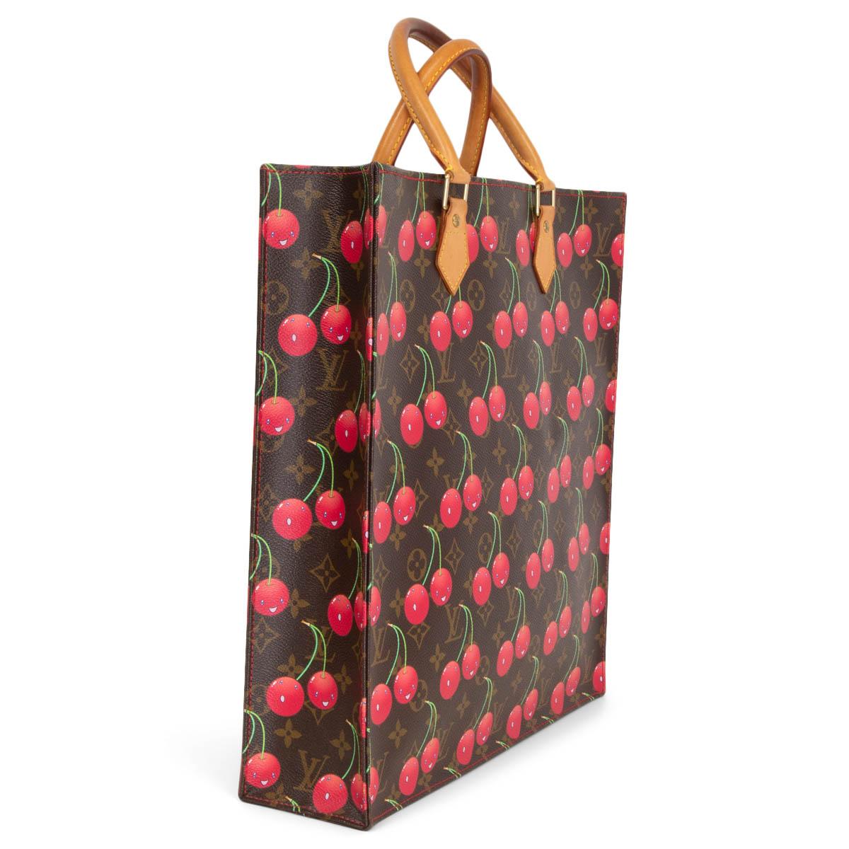 100% authentic Louis Vuitton x Takashi Murakami 2005 Sac Plat Tote in brown Monogram Cerises canvas with a cherry-print by artist Takashi Murakami. This tall tote features vachetta leather cowhide rolled top handles with brass links. The top is open