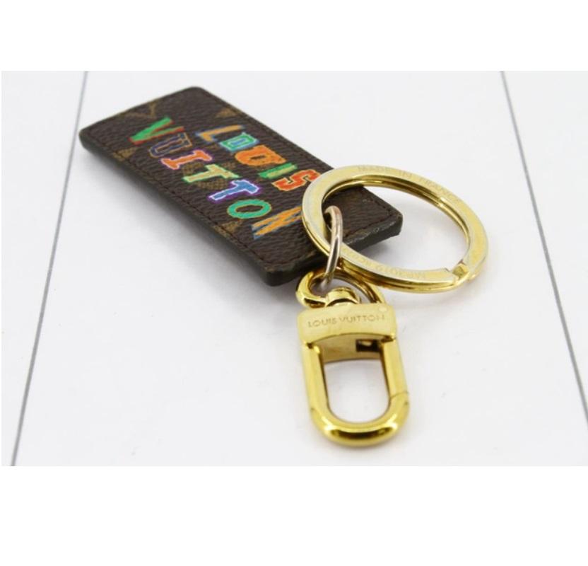 Louis Vuitton x NBA key chain features gold-tone hardware, brown and tan Monogram coated canvas with printed NBA logo at front and multicolor Louis Vuitton letters at back and D-ring hook closure.

67300MSC