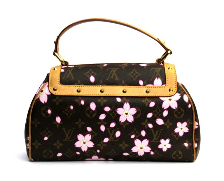 The Louis Vuitton Limited Edition Cherry Blossom Sac Retro Bag is an ultra-rare piece from the Spring/Summer 2003 Collection. This is a timeless and feminine bag that Louis Vuitton lovers everywhere want to collect. With its vintage flair, beautiful