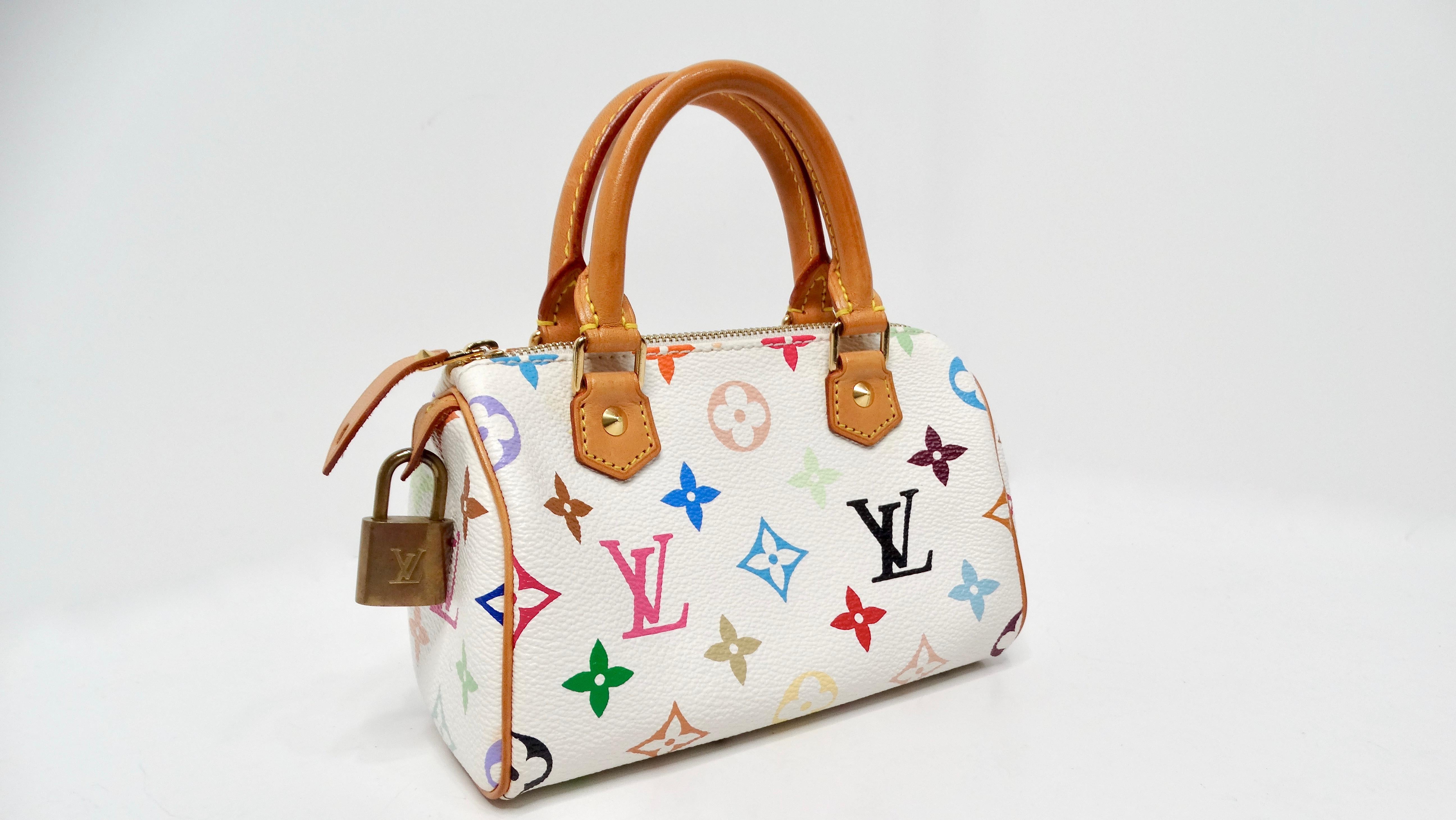 The Louis Vuitton x Takashi Murakami Y2K White Multicolor Mini Speedy Handbag is a stunning fusion of luxury and art, embodying the playful essence of early 2000s fashion. Crafted from premium white canvas adorned with a vibrant multicolor monogram,