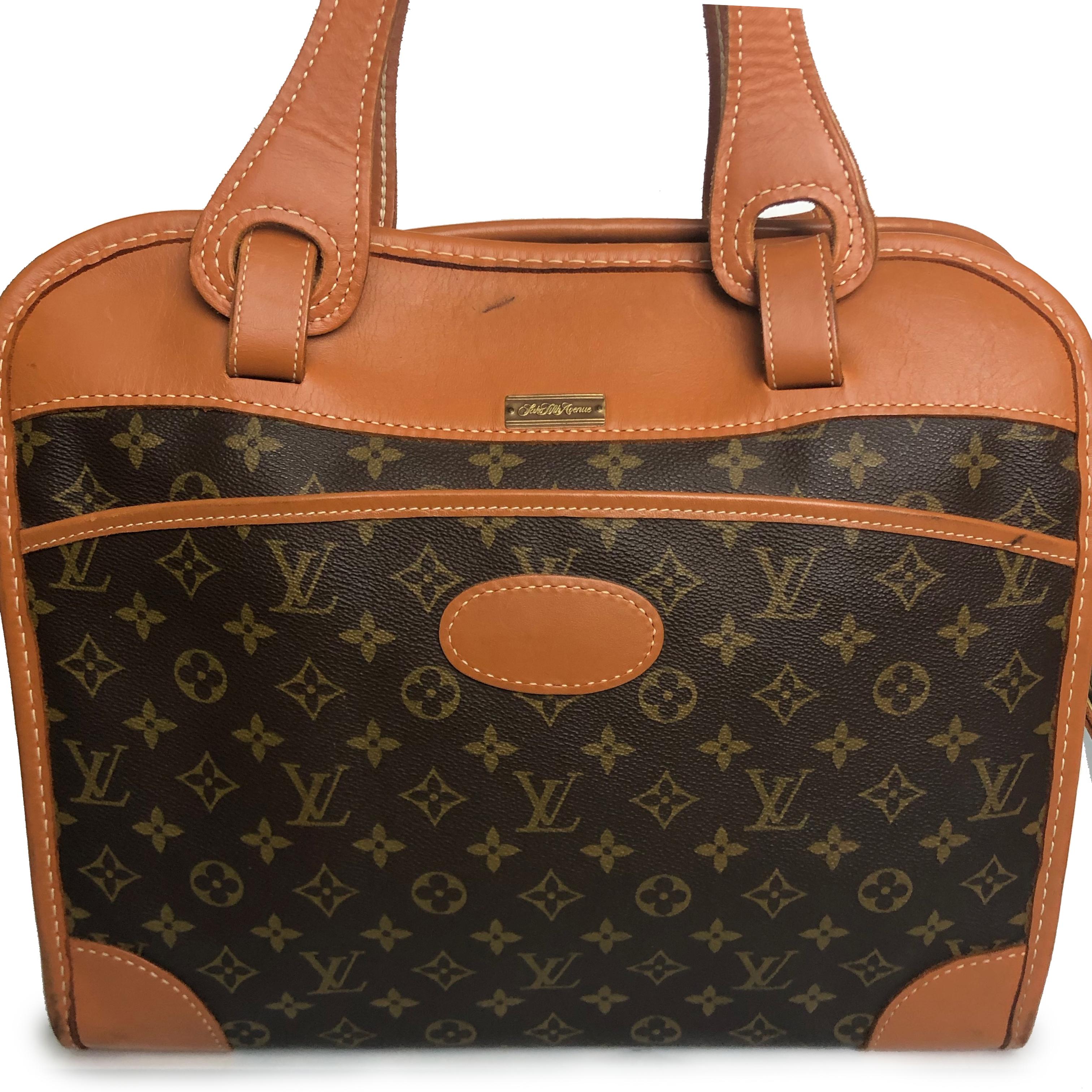 Authentic, preowned, late 70s Louis Vuitton x French Luggage Company diaper bag carry on travel bag. Sold by SAKS FIFTH AVE. Monogram canvas, coated leather trim. Open pocket outside; fastens with zipper; interior lined with plastic coated fabric
