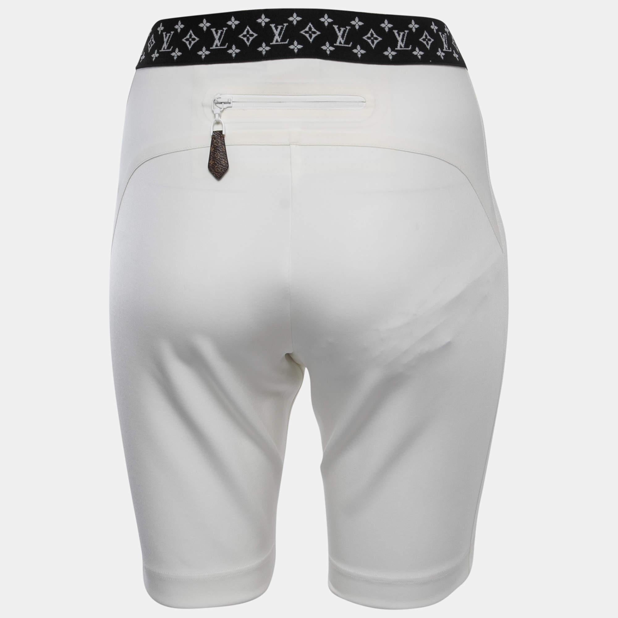 The Louis Vuitton x URS Fischer cycling shorts are a high-fashion collaboration piece. They feature a sleek off-white design with the iconic LV monogram, designed by artist Urs Fischer. These cycling shorts blend luxury fashion with sporty