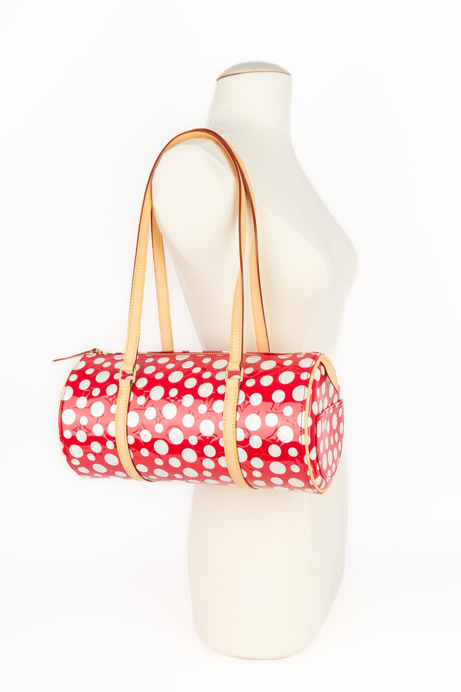 LOUIS VUITTON - (Made in France) Patent coated canvas butterfly bag embossed with red monogram and white dots, ornamented with natural leather, golden brass, and a padlock and its keys. Large size. A 2012 Collection - limited