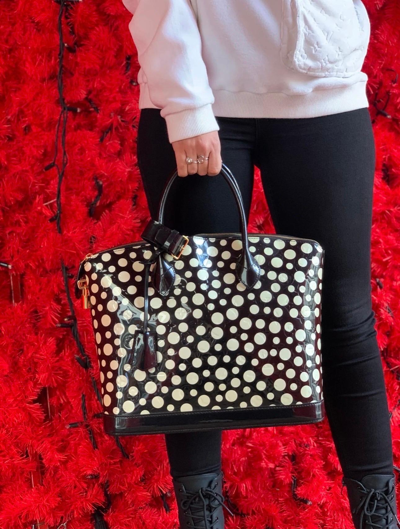Limited Edition bag by Louis Vuitton x Yayoi Kusama in polka dot patent leather with gold hardware. It has a zip closure with padlock and special keys for opening. The interior is lined with a soft fabric and is equipped with 3 internal pockets