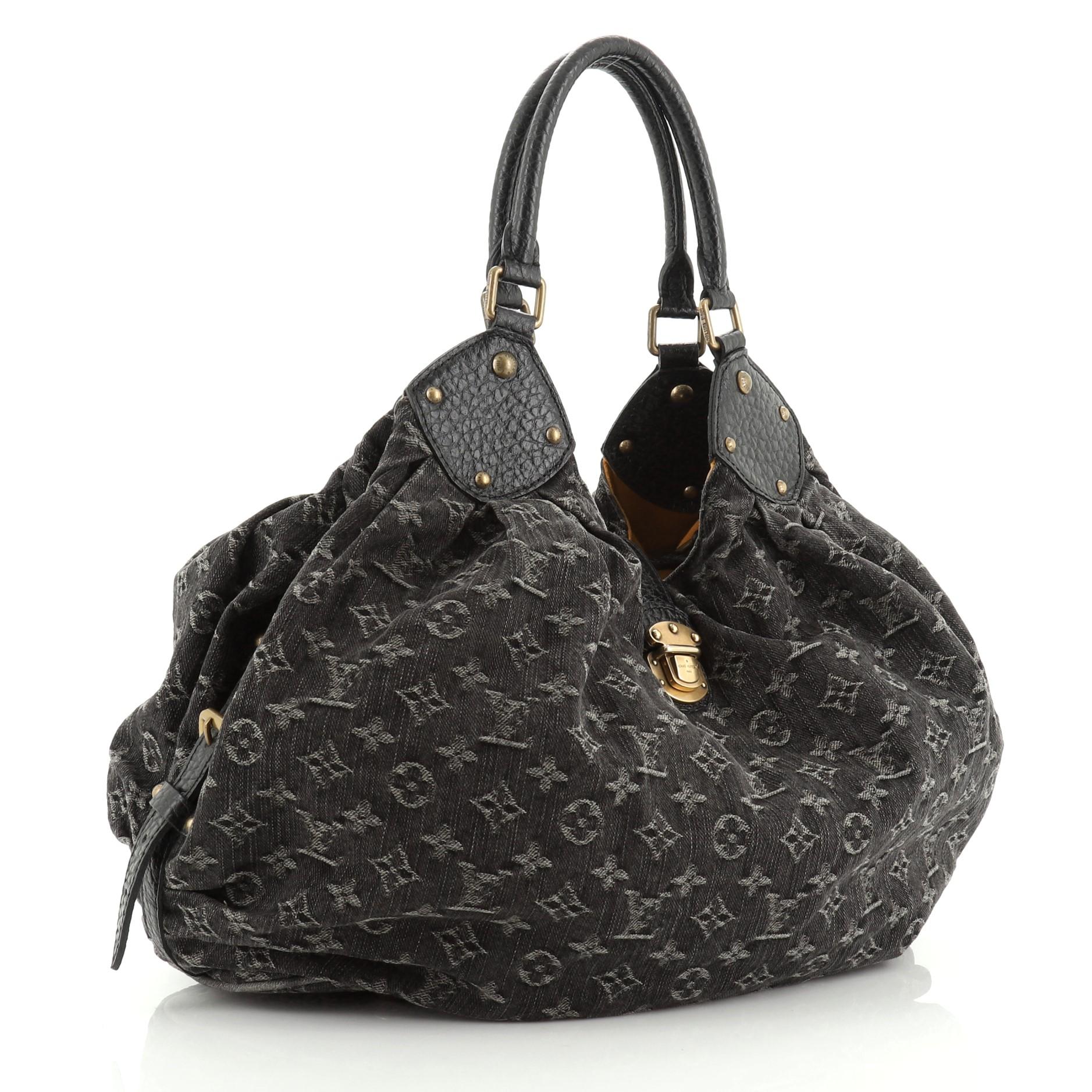 This Louis Vuitton XL Hobo Denim is an everyday bag that unites timeless design with heritage details. Crafted from black monogram denim, features dual rolled handles, buckle and stud details, side belt strap, protective base studs, and aged