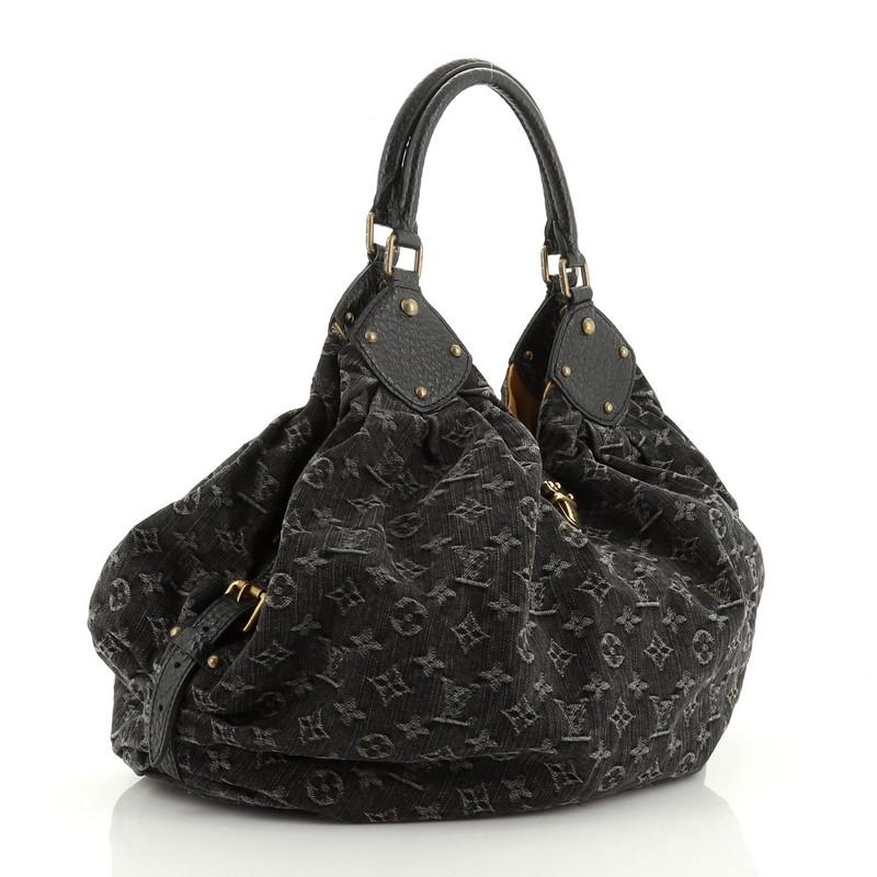 This Louis Vuitton XL Hobo Denim, crafted from black monogram denim, features dual rolled handles, buckle and stud details, side belt strap, protective base studs, and aged gold-tone hardware. Its engraved top flap push-lock closure opens to a