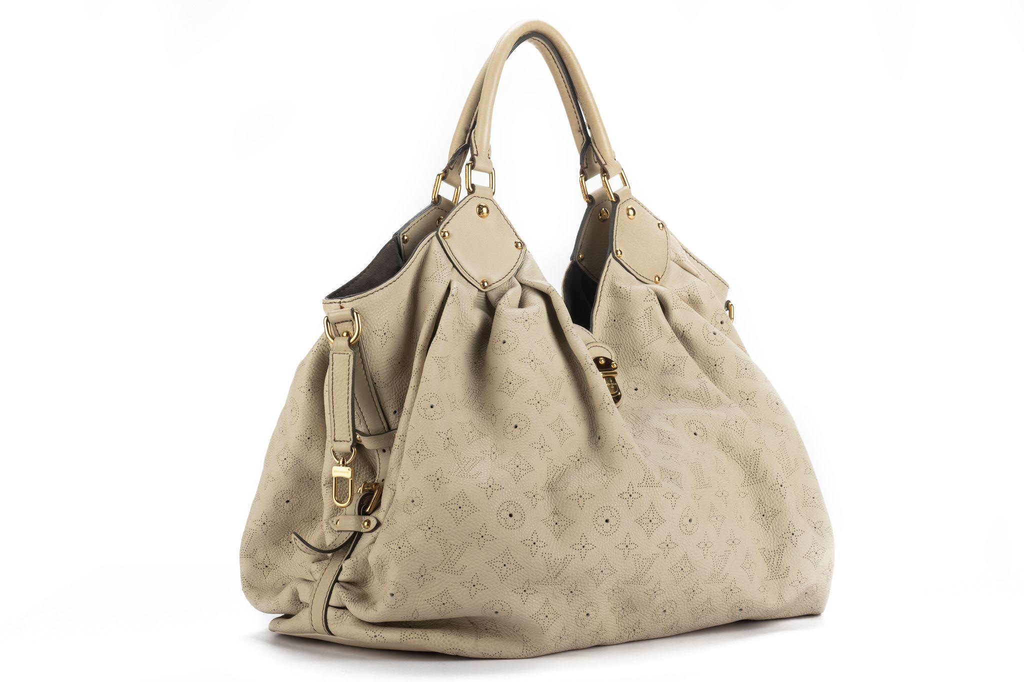 Louis Vuitton extra large cream mahina shoulder bag. Logo perforated leather and gold tone hardware. Excellent condition except minor red marks in the back, please refer to photos. Handle drop 9.5”. Comes with generic dust cover.