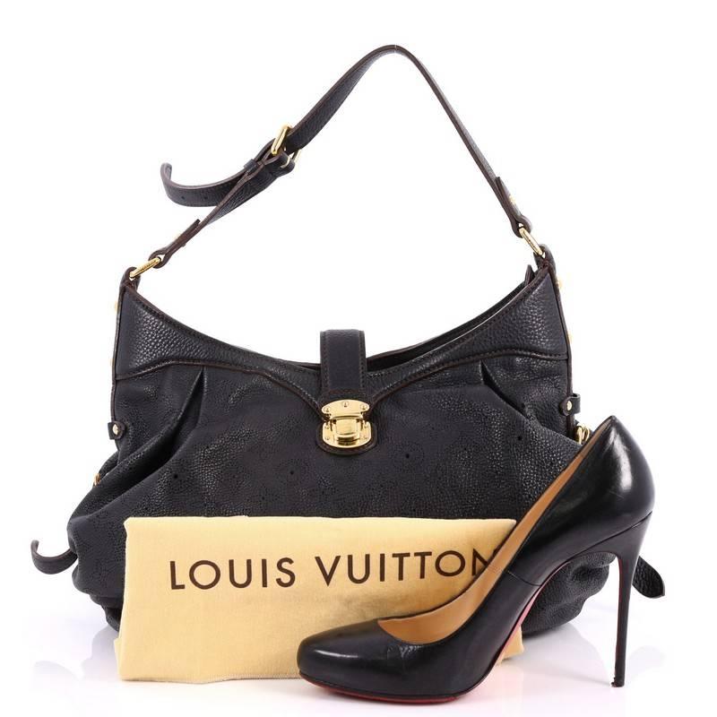 This authentic Louis Vuitton XS Crossbody Bag Mahina Leather is both stylish and functional. Crafted from black monogram perforated mahina leather, this shoulder bag features an adjustable leather strap, protective base studs, top belted strap with