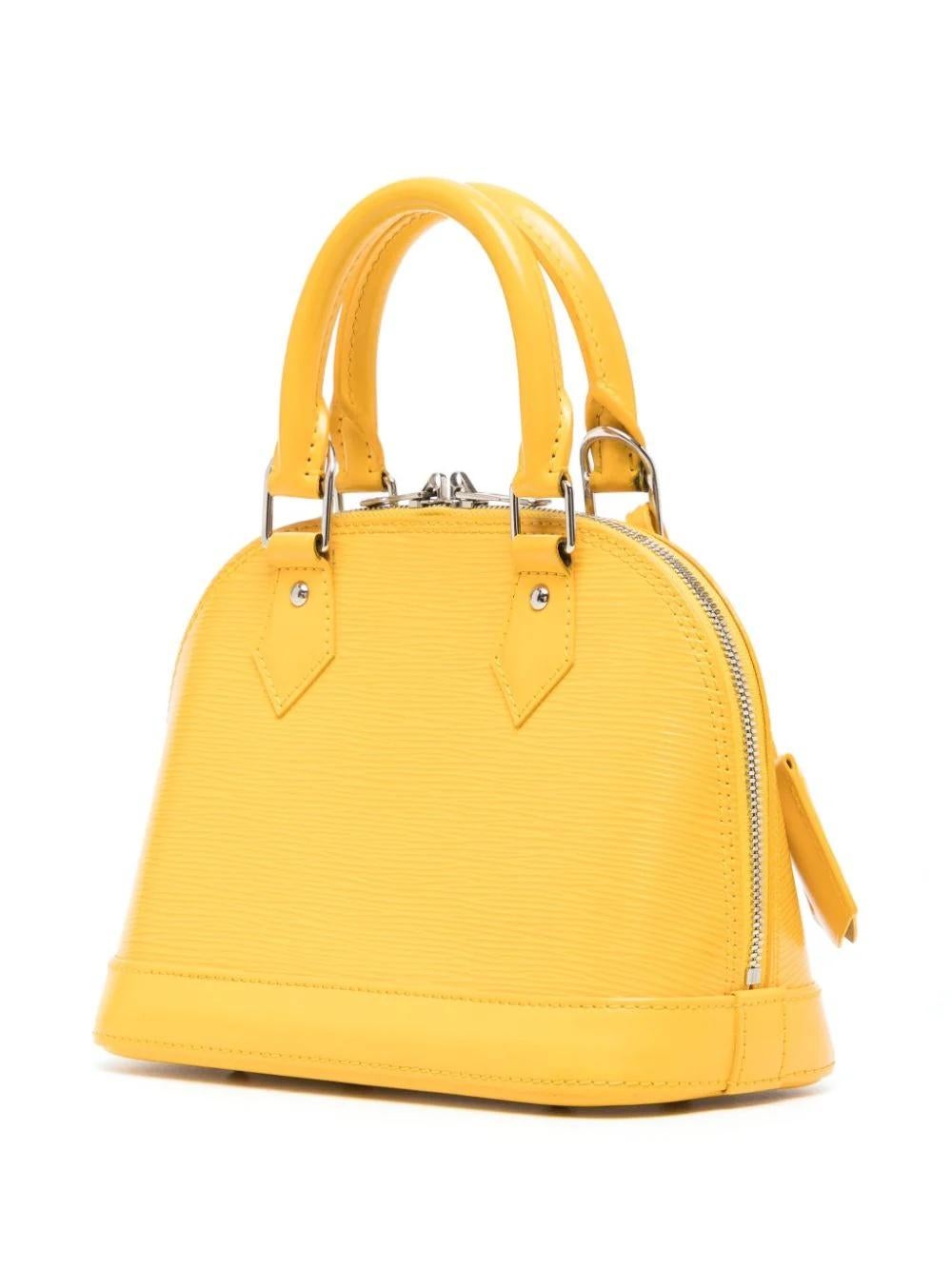 * Mustard yellow
* Épi leather
* Debossed logo to the front
* Two rolled top handles
* Two-way zip fastening
* Detachable shoulder strap
* Main compartment
* Internal slip pocket
* Suede lining
* Metal feet
* Hanging key fob
* Silver-tone hardware
*