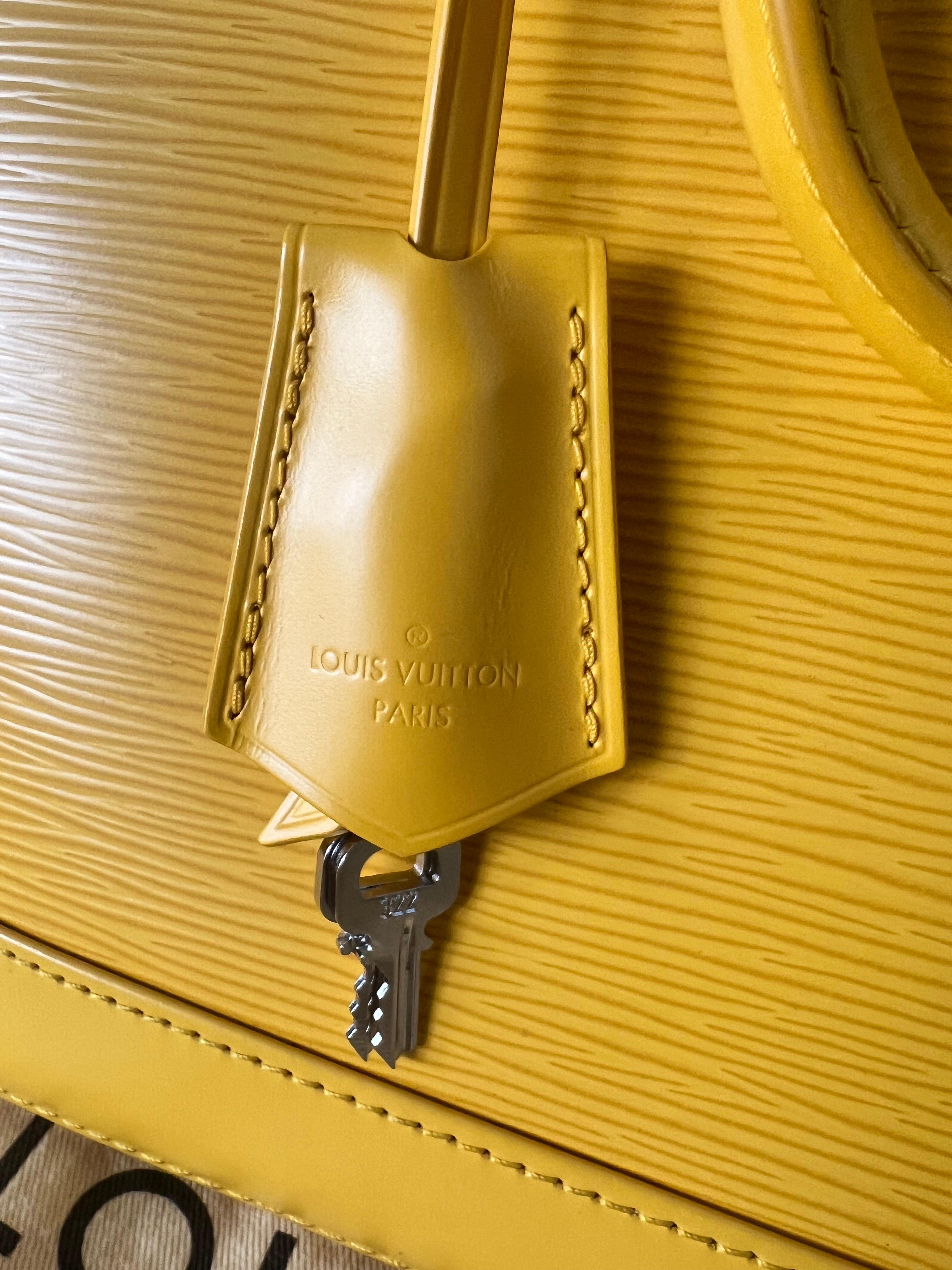
The Louis Vuitton Yellow Epi Alma PM, as you described it, is a distinctive and stylish handbag that combines the iconic design of the Alma with vibrant details. Here's a breakdown of its features:

Color and Material:
The use of yellow Epi leather