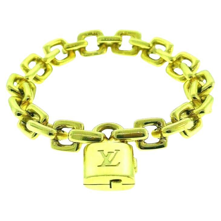 Bold and chunky 18k yellow gold Louis Vuitton chain bracelet with a detachable locket charm that works as a clasp. Can be a great charm bracelet, or a layering piece, but looks absolutely stunning by its own as well.  
The lock features the LV logo.