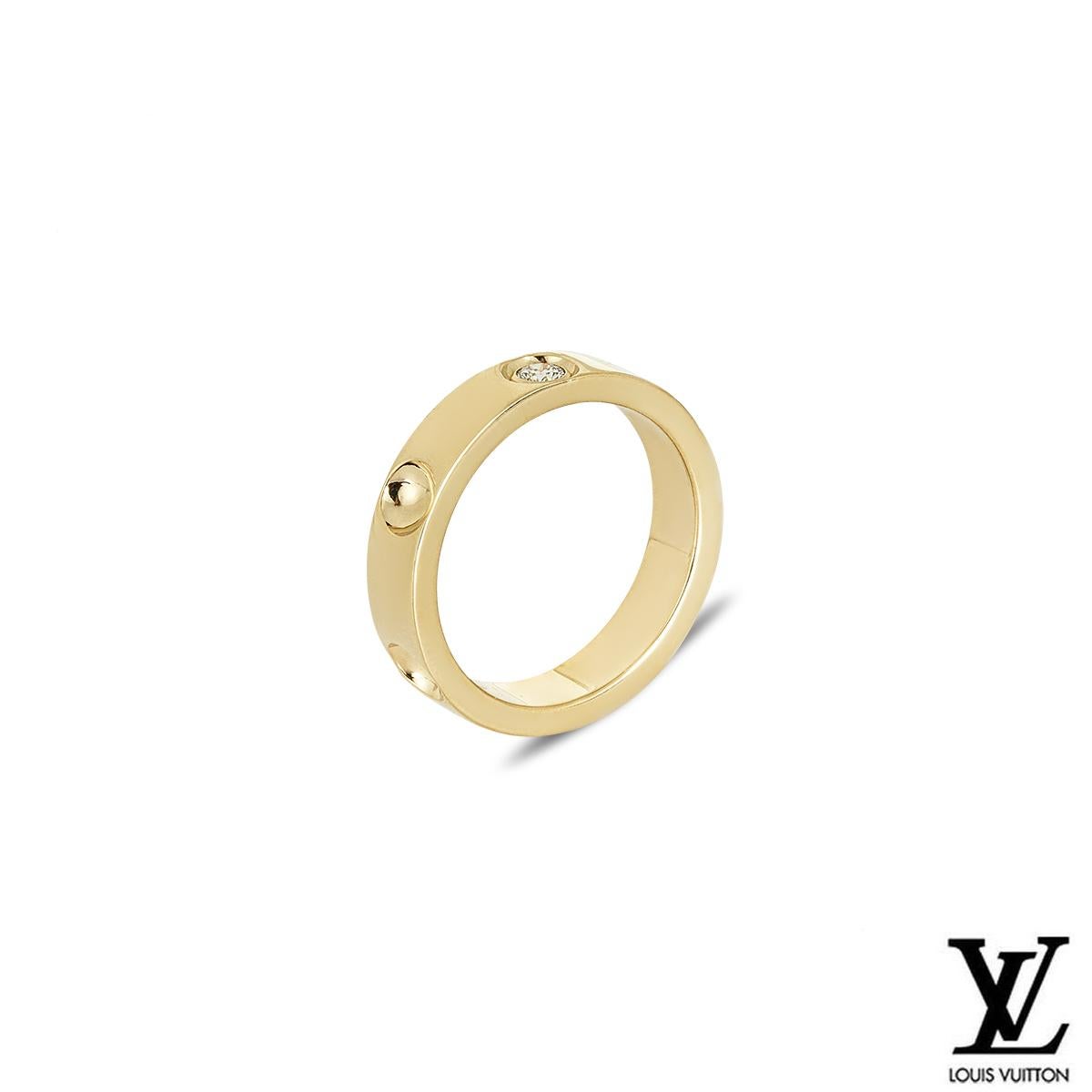 A stunning 18k yellow gold ring from the Empreinte collection by Louis Vuitton. The ring features 5 inverted stud motifs, one engraved with the Louis Vuitton logo. The ring is set with a single round cut diamond, weighing approximately 0.10ct. The