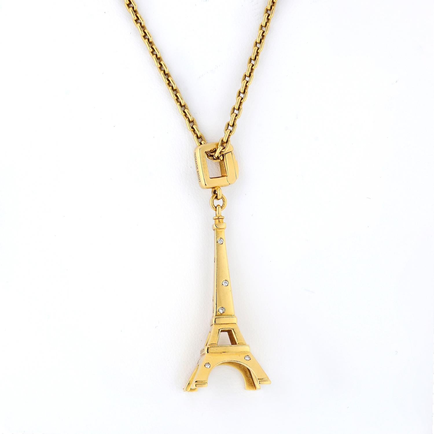 Elite and authentic from Louis Vuitton, this gorgeous charm or pendant on an original chain is crafted from 18k yellow gold with a high polished finish featuring the popular and iconic Eiffel Tower in Paris. Scattered along the tower are flush set