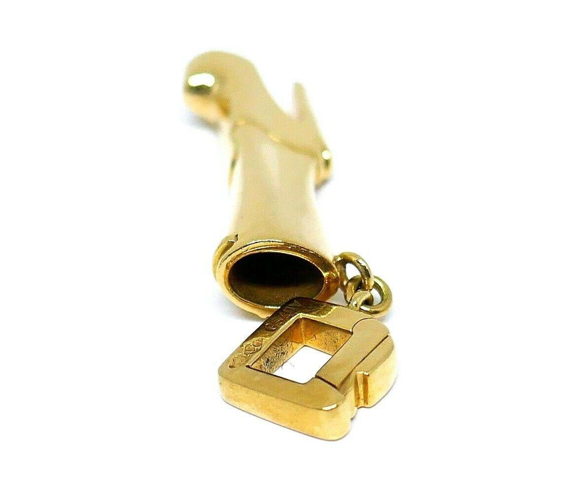 Bold and heavy charm made of 18k yellow gold  by Louis Vuitton. Features an opening/closing clasp stamped with the Louis Vuitton maker's mark, hallmark for 18k gold and a serial number. Also has a LV logo stamped on the sole.
Measurements: 7/8